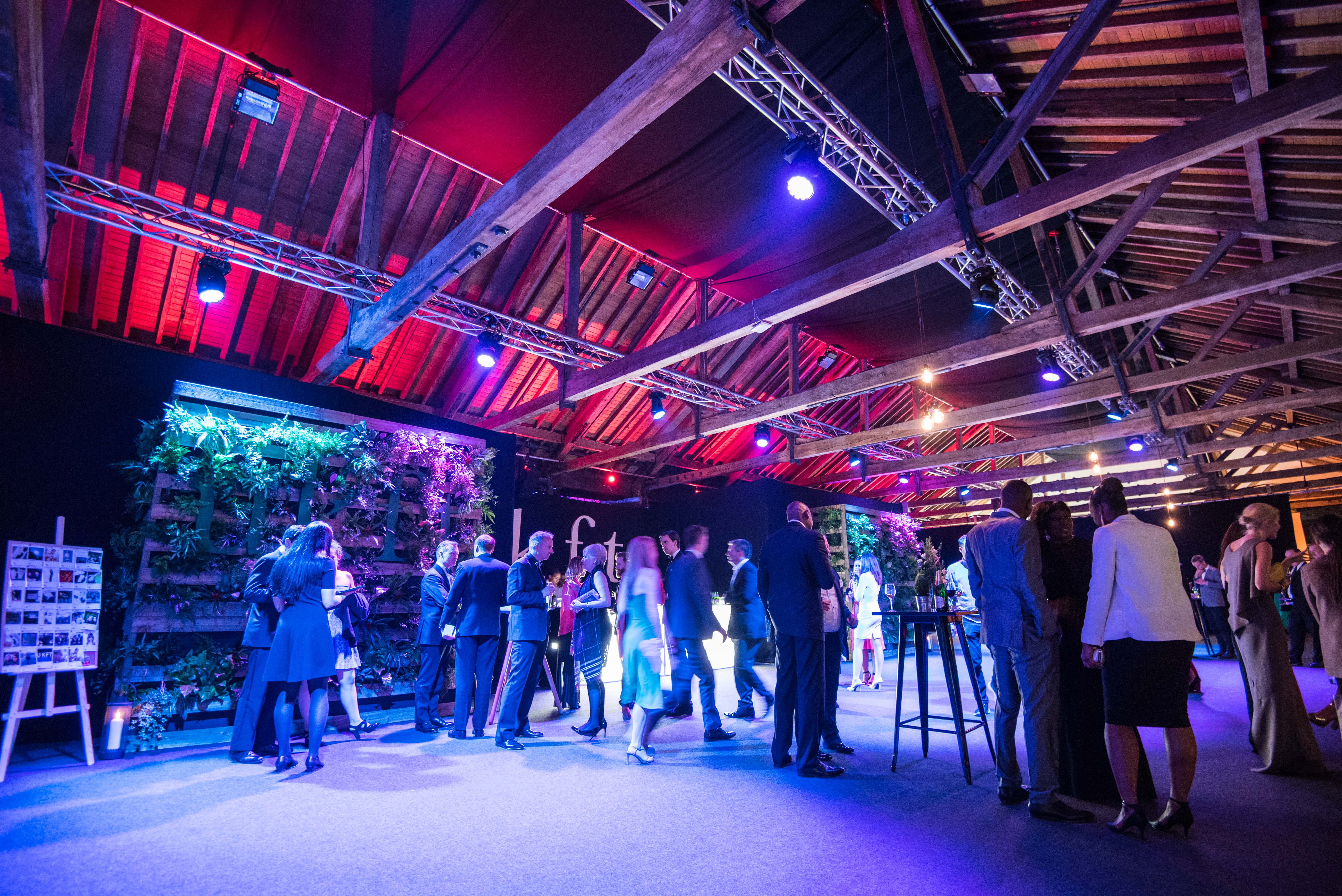 Networking reception at Little Gallery Tobacco Dock featuring a living wall and mood lighting.