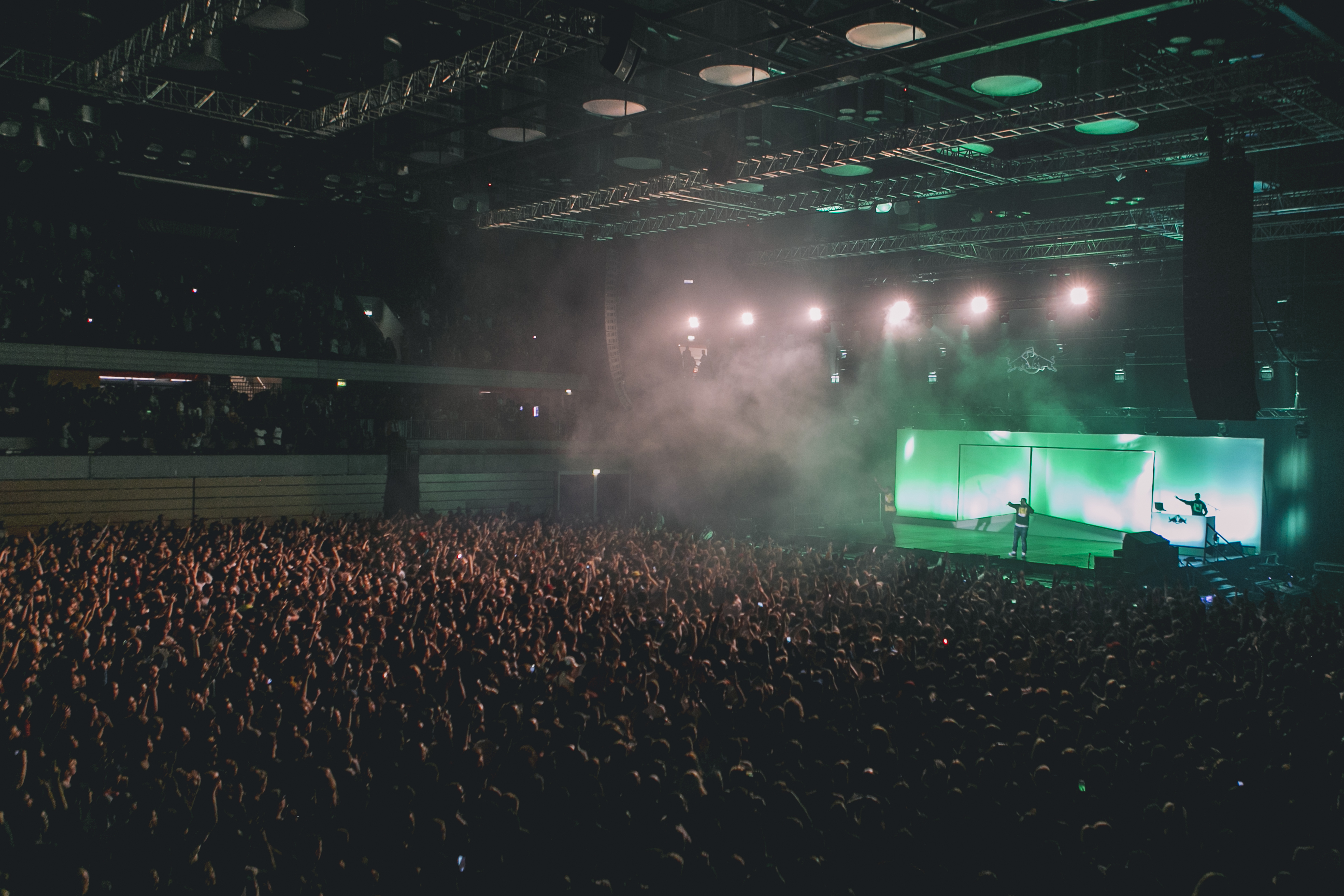 Packed Copper Box Arena with vibrant crowd and dynamic stage lighting for events.