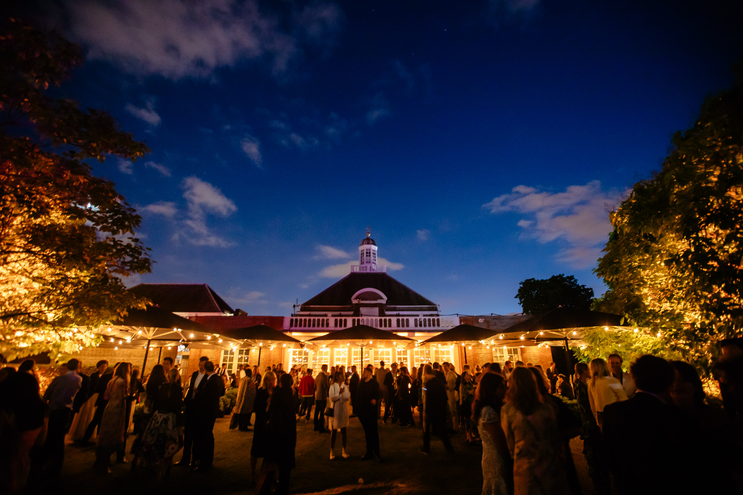 Serpentine Galleries evening reception with ambient lighting for corporate networking events. - Banner