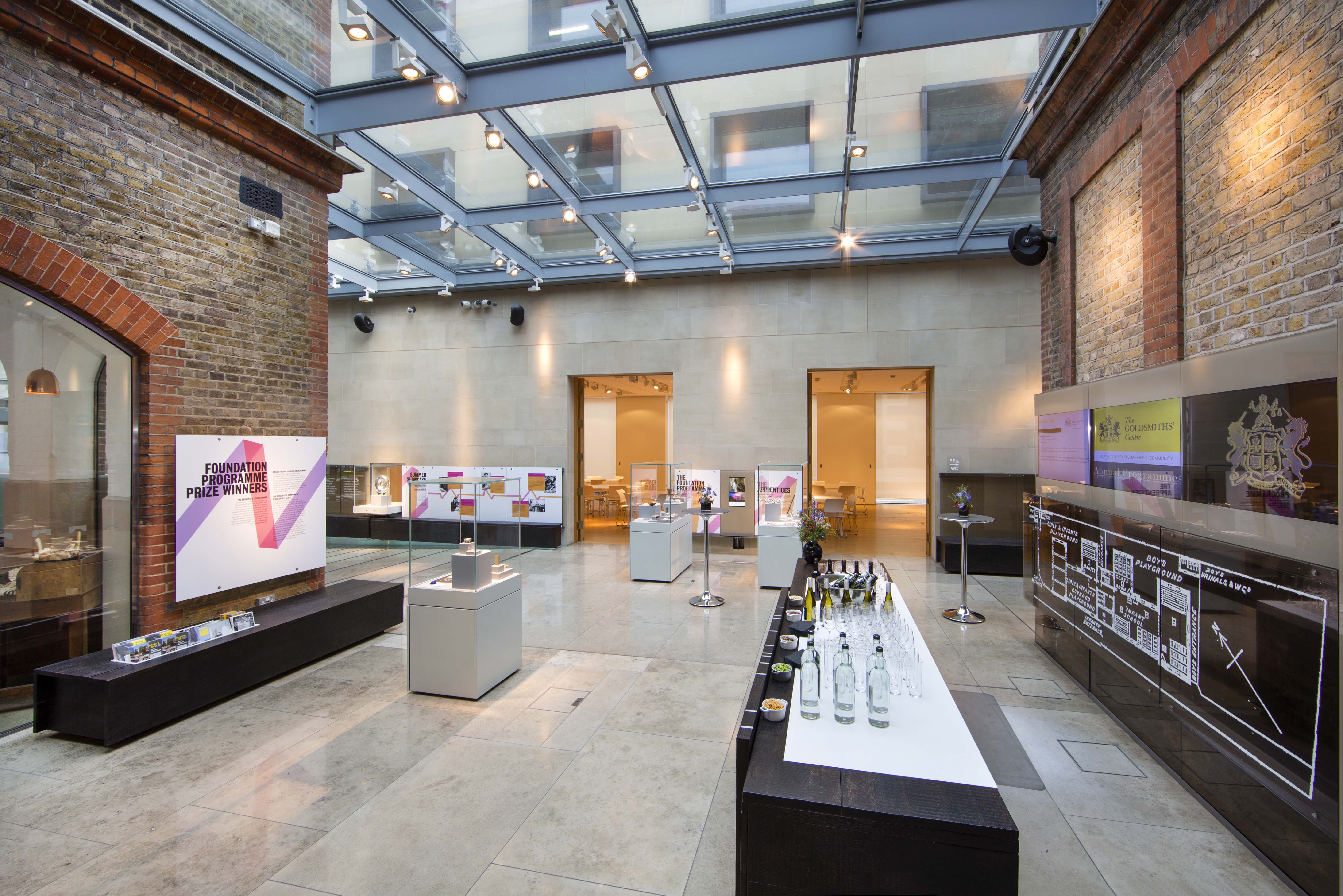 Atrium at The Goldsmiths' Centre, modern event space with glass ceiling for networking and exhibitions.