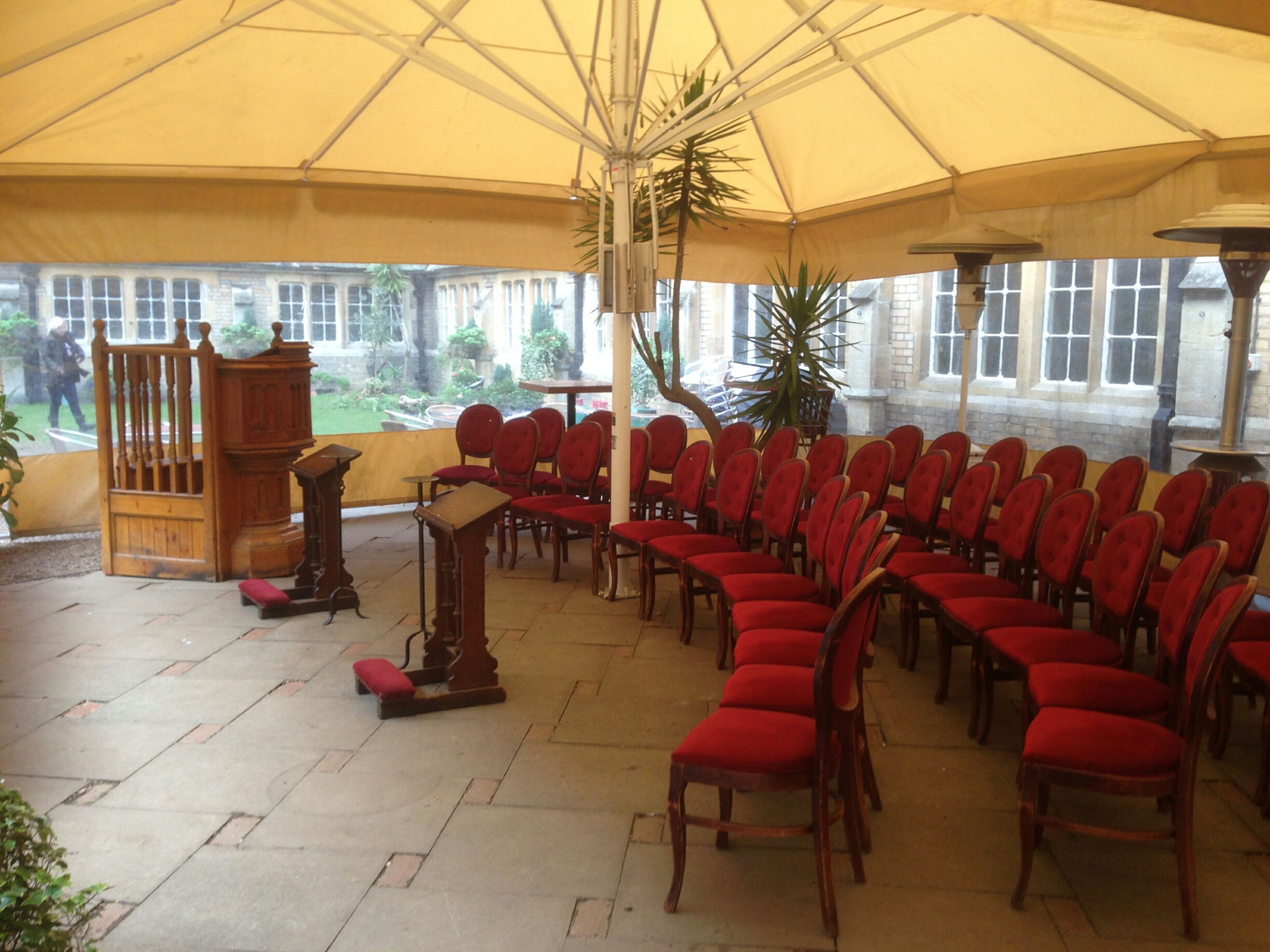 Elegant outdoor event space with red chairs, perfect for weddings and corporate gatherings. - Banner