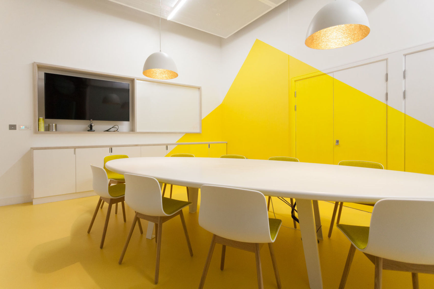 Sunnyvale Meeting Room with yellow accent wall for collaborative meetings and presentations.