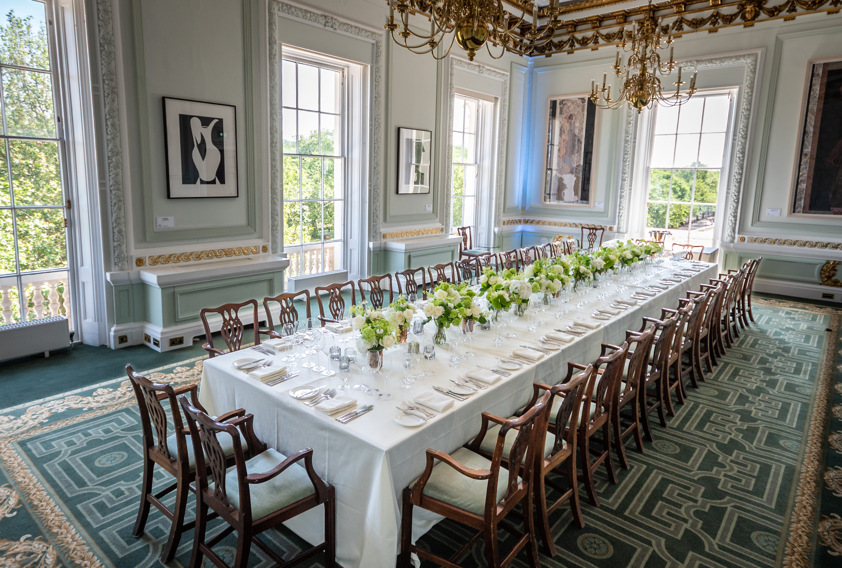 Elegant banquet table with floral centerpieces in Radhakrishnan Room, ideal for corporate events.