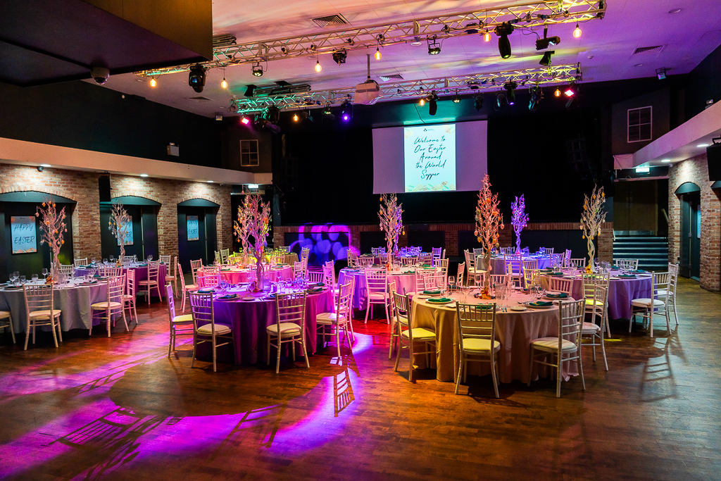 Elegant event space with round tables, perfect for weddings and corporate gatherings.