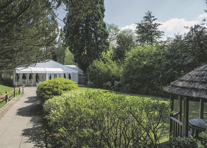 Serene outdoor venue at New Hall Hotel, ideal for corporate retreats and social gatherings. - Banner