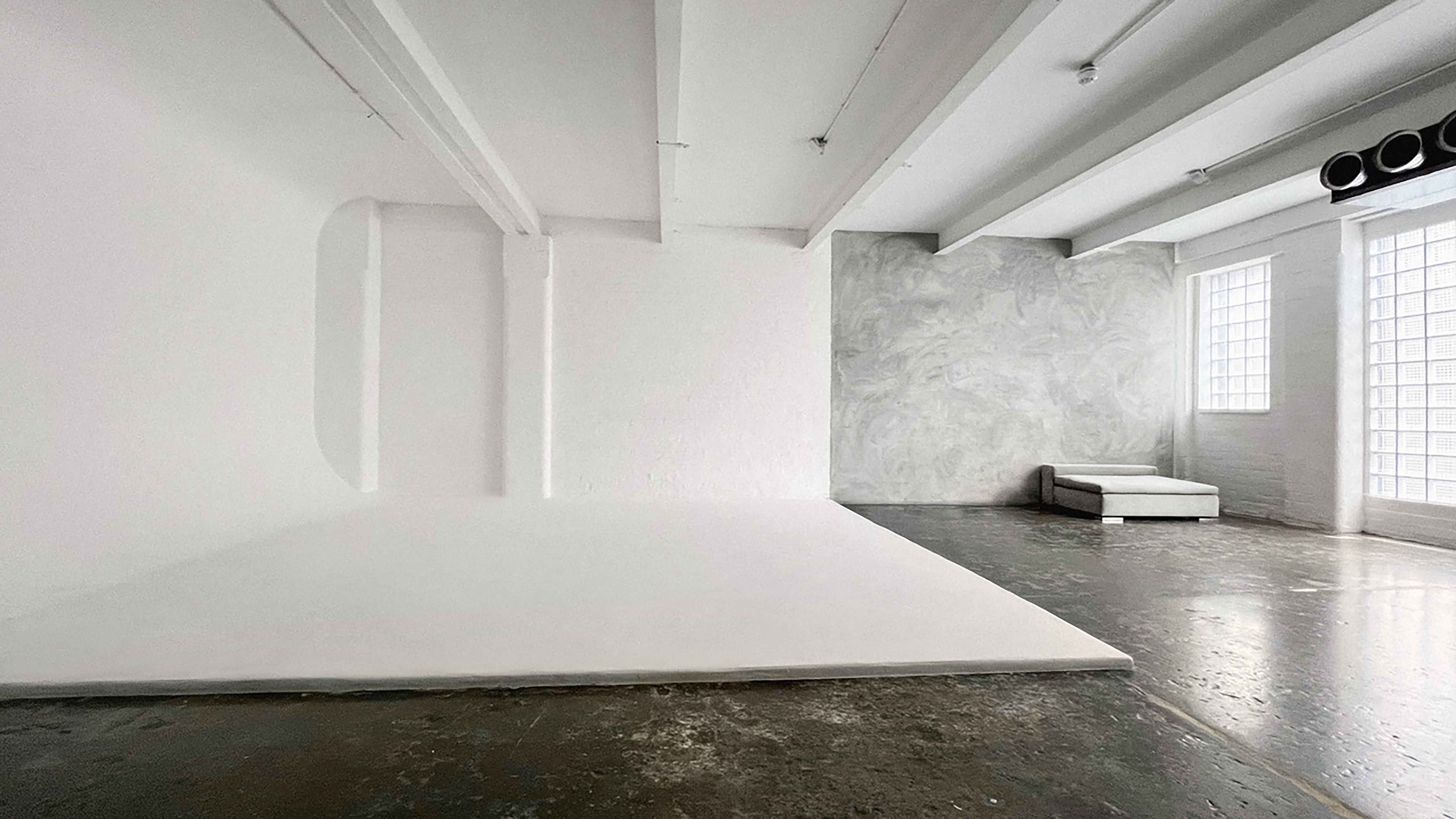Versatile minimalist event space with natural light for workshops and product launches.