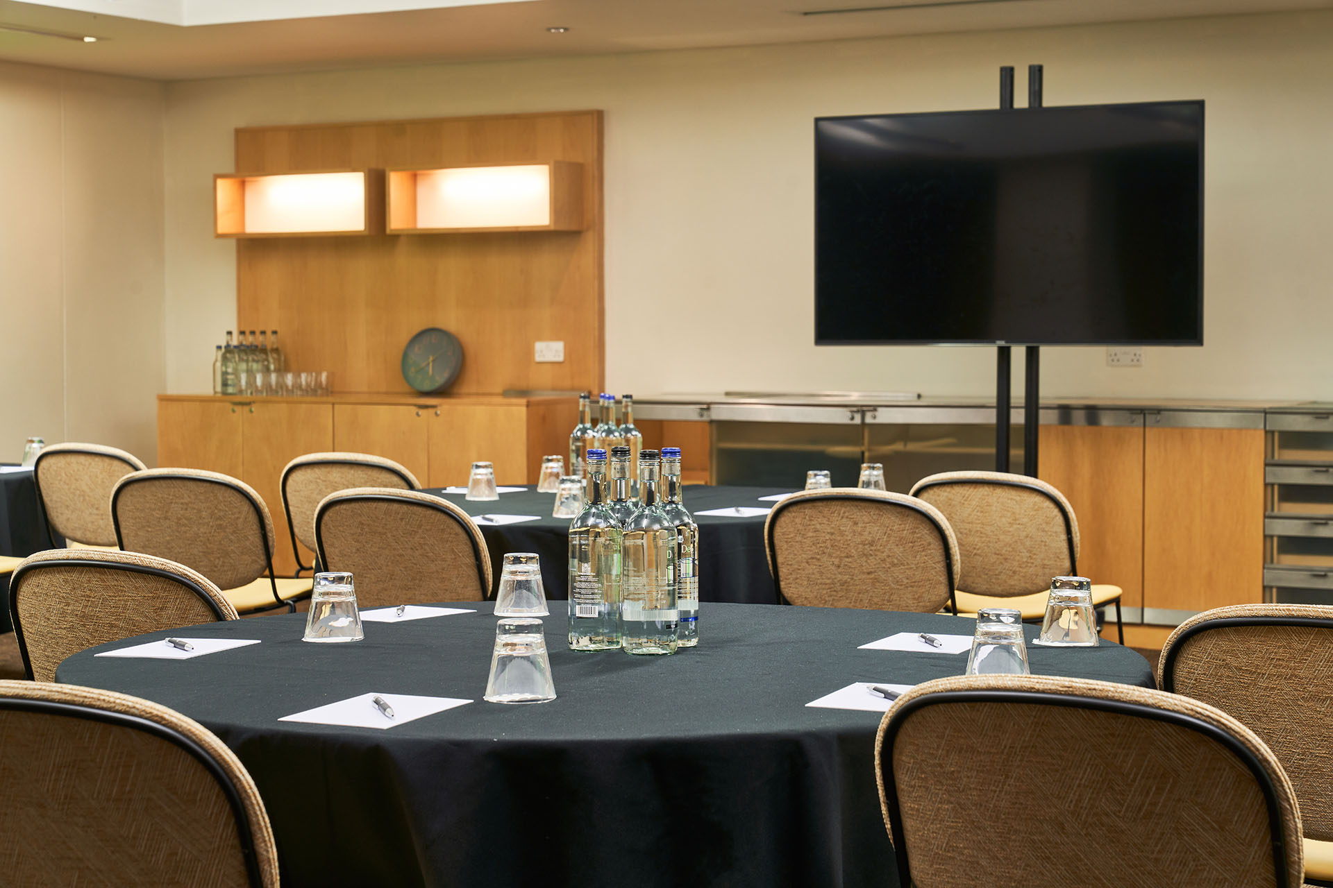 Meeting room at The Cumberland Hotel with round tables, ideal for corporate events.