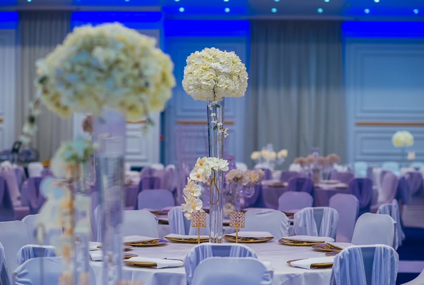 Elegant event space in The Coliseum Suite with tall floral centerpieces for weddings. - Banner