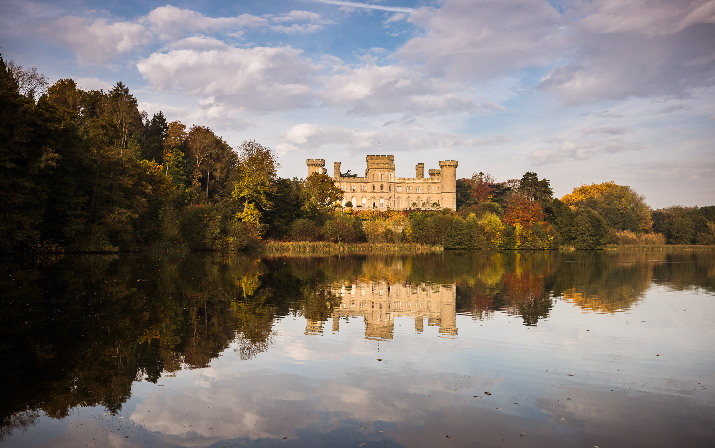 Eastnor Castle venue with autumn colors, perfect for corporate retreats and weddings. - Banner