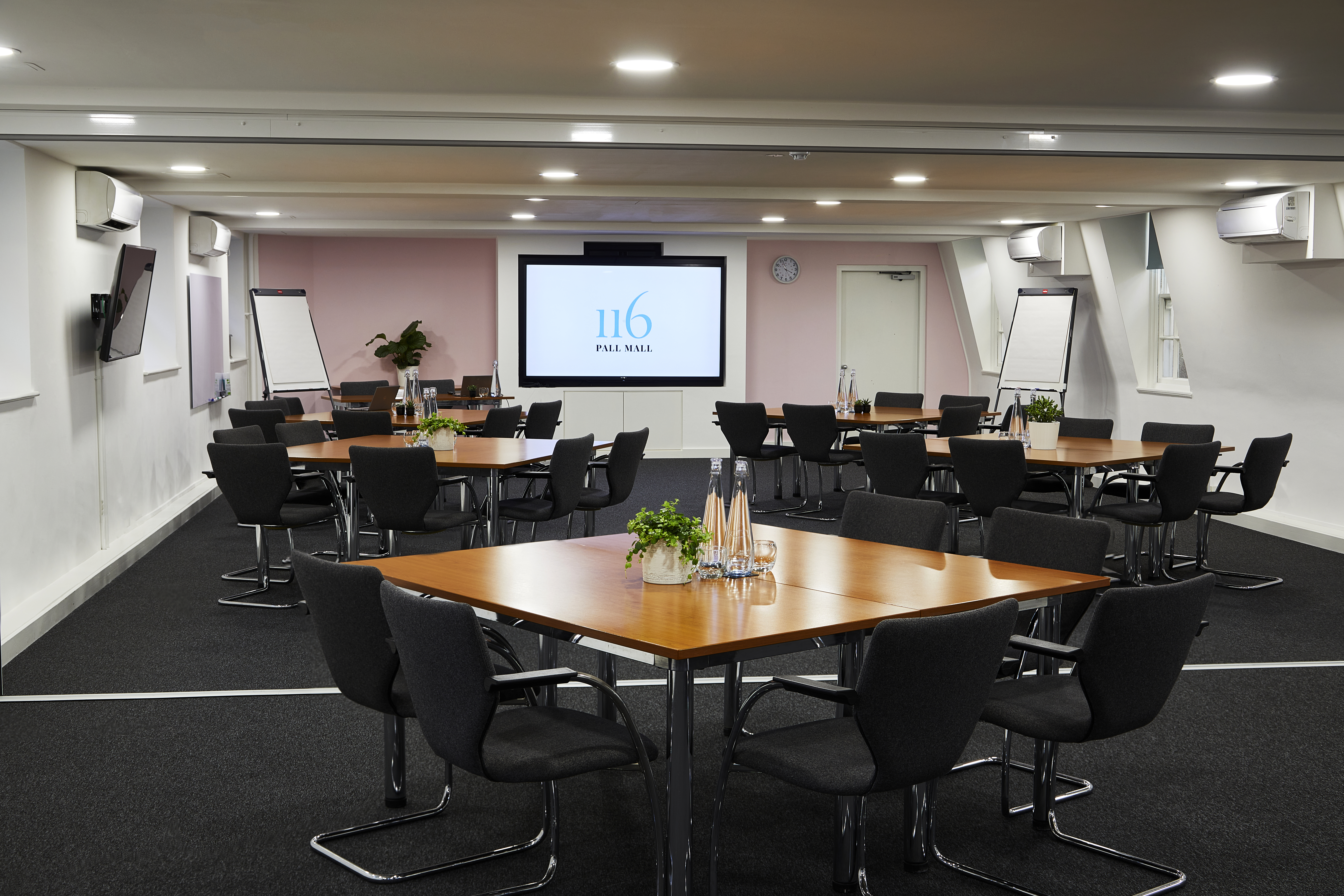 Modern London meeting room, natural light, flexible seating, corporate events.