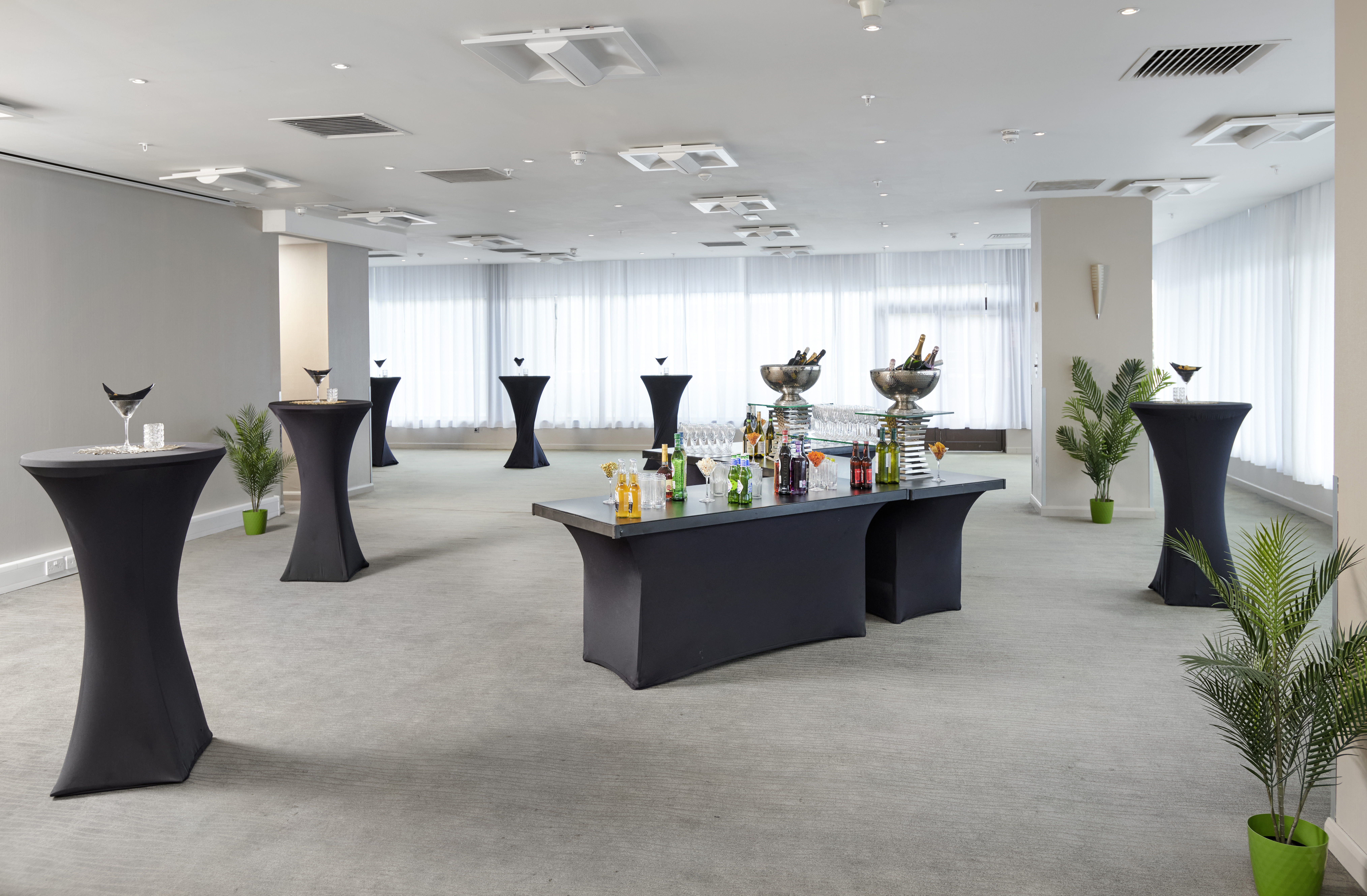 Modern Cognac Suite event space with high-top tables for cocktail receptions and networking.