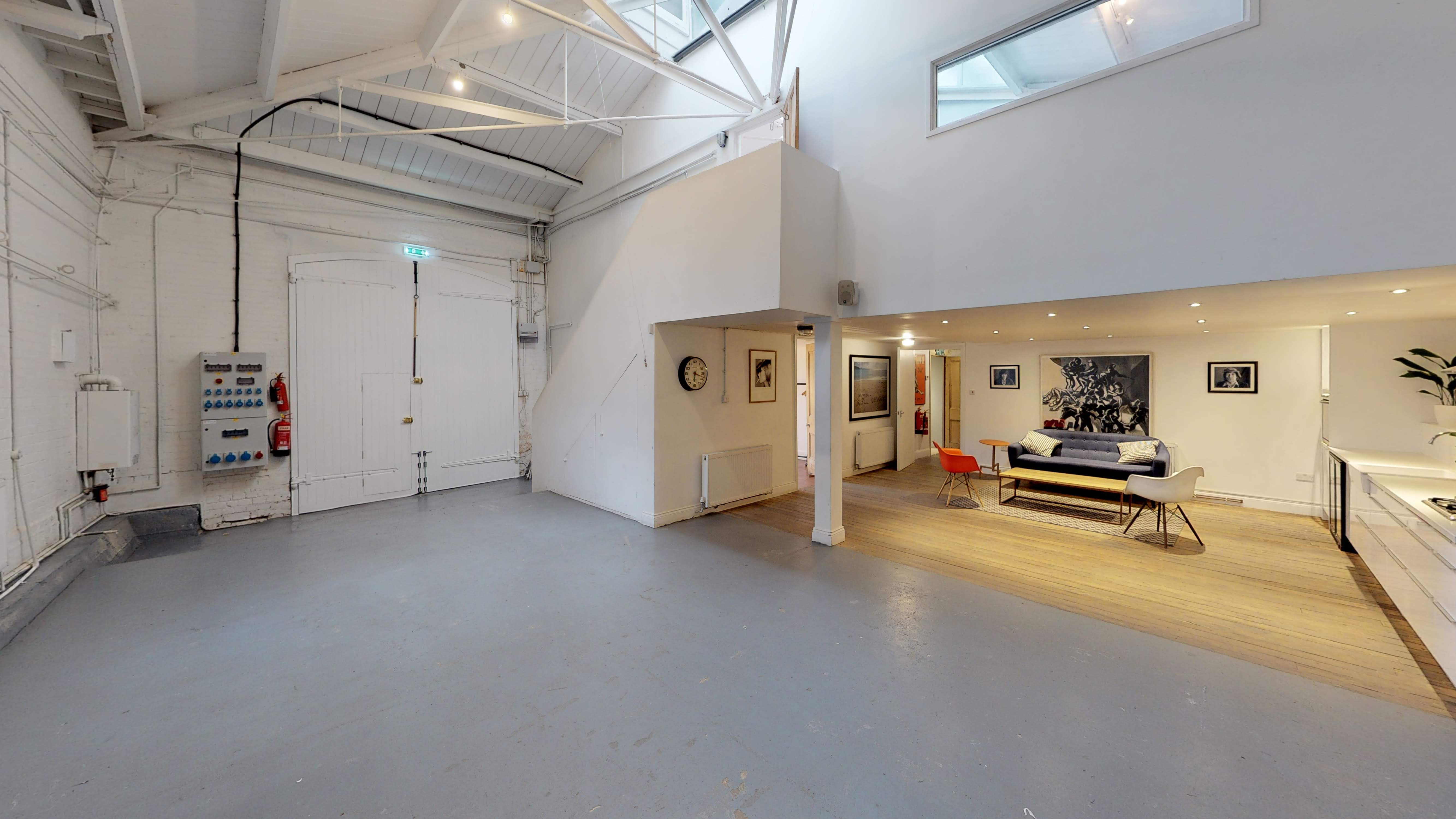 Versatile event space in Park Village with high ceilings for corporate meetings and gatherings. - Banner