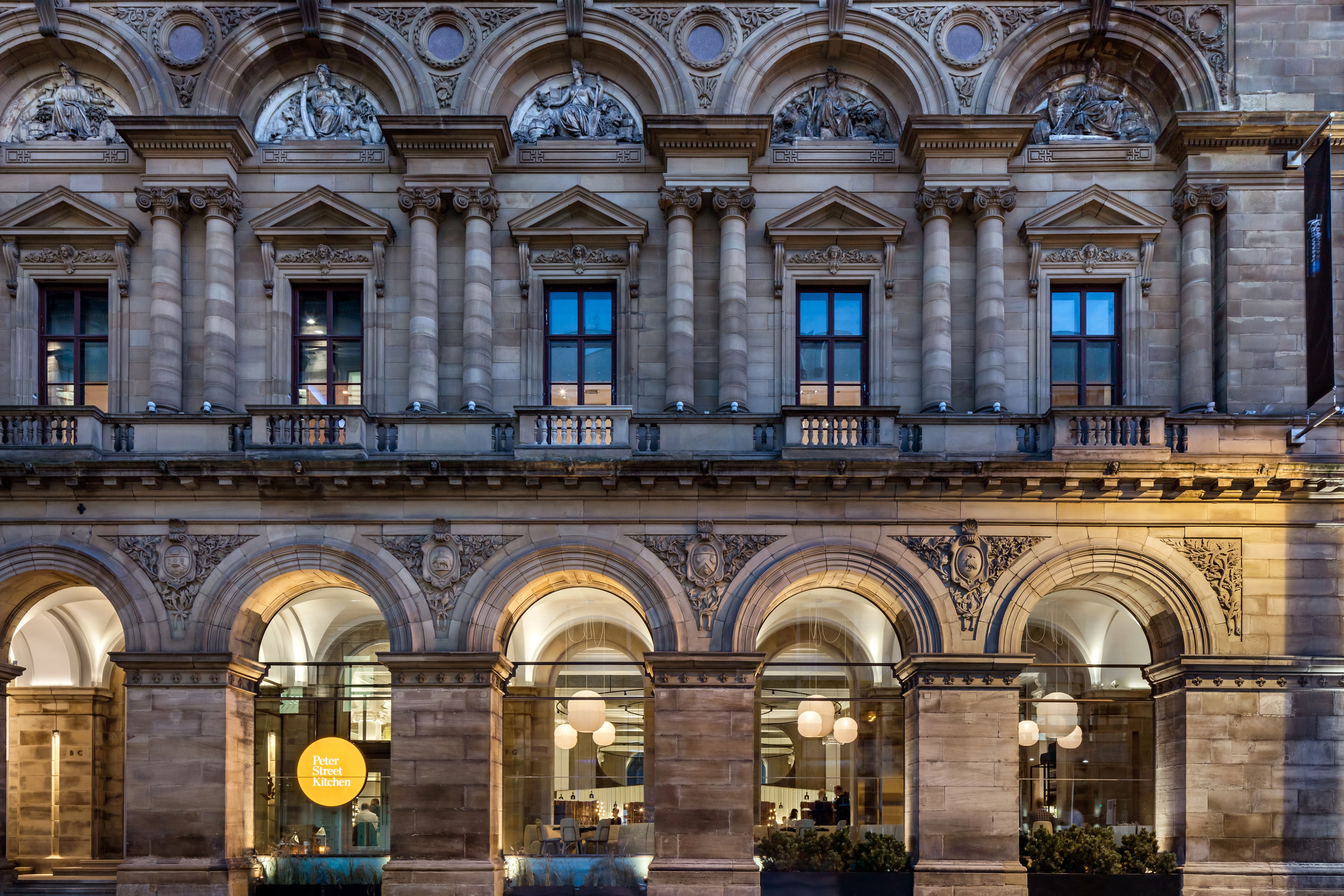 Elegant hotel facade with grand columns, perfect for upscale events and conferences. - Banner