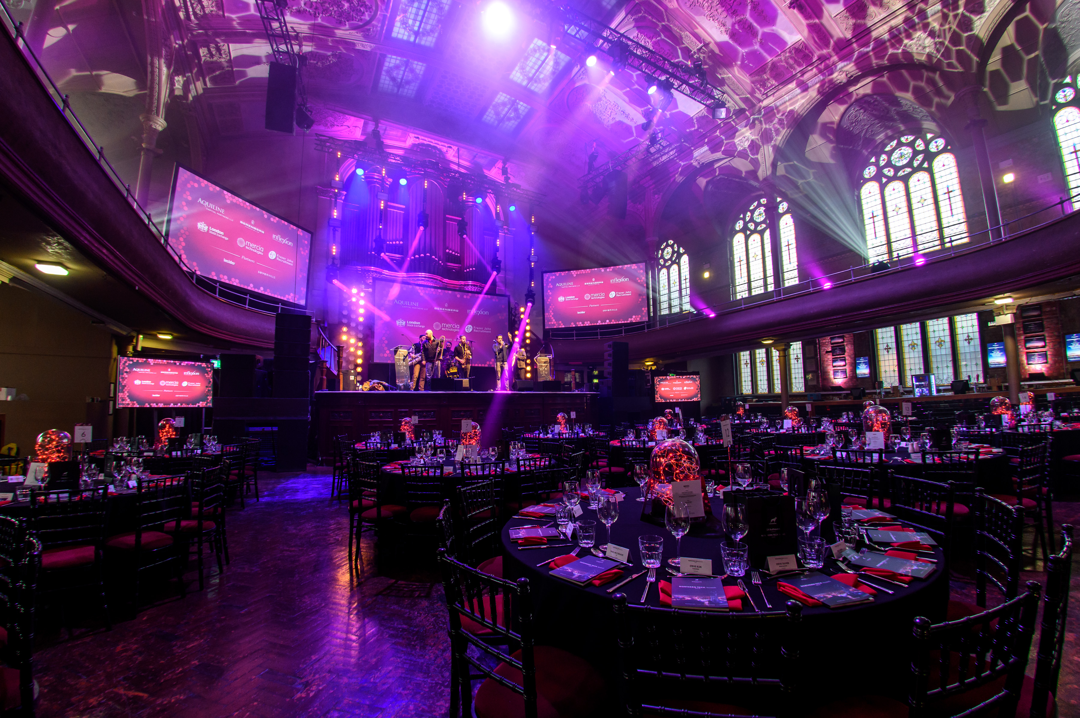 Gala setup in Royal Albert Hall featuring banquet seating and AV production for corporate events. - Banner