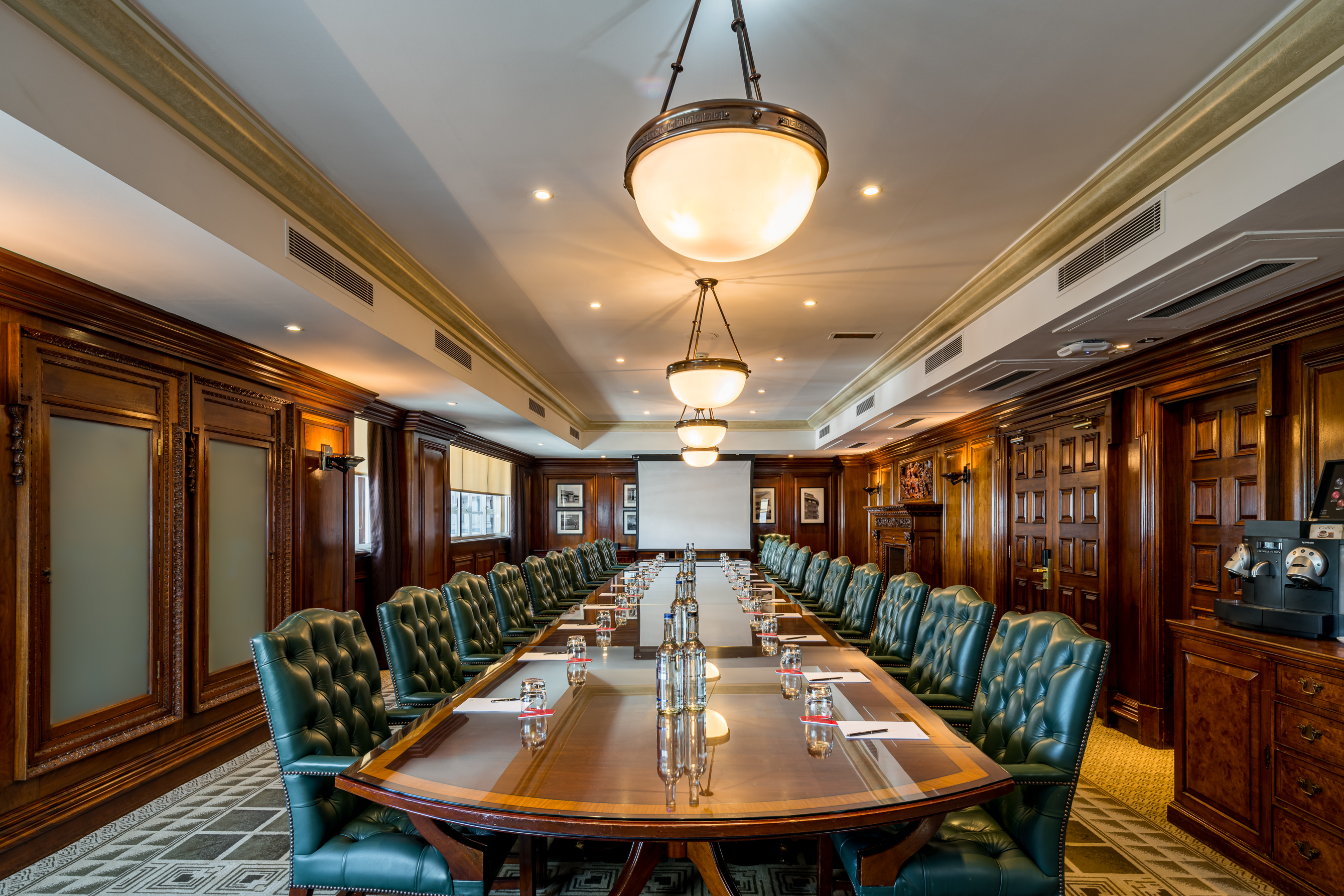 Sophisticated boardroom at Speakers' Corner, polished table, ideal for meetings and presentations.