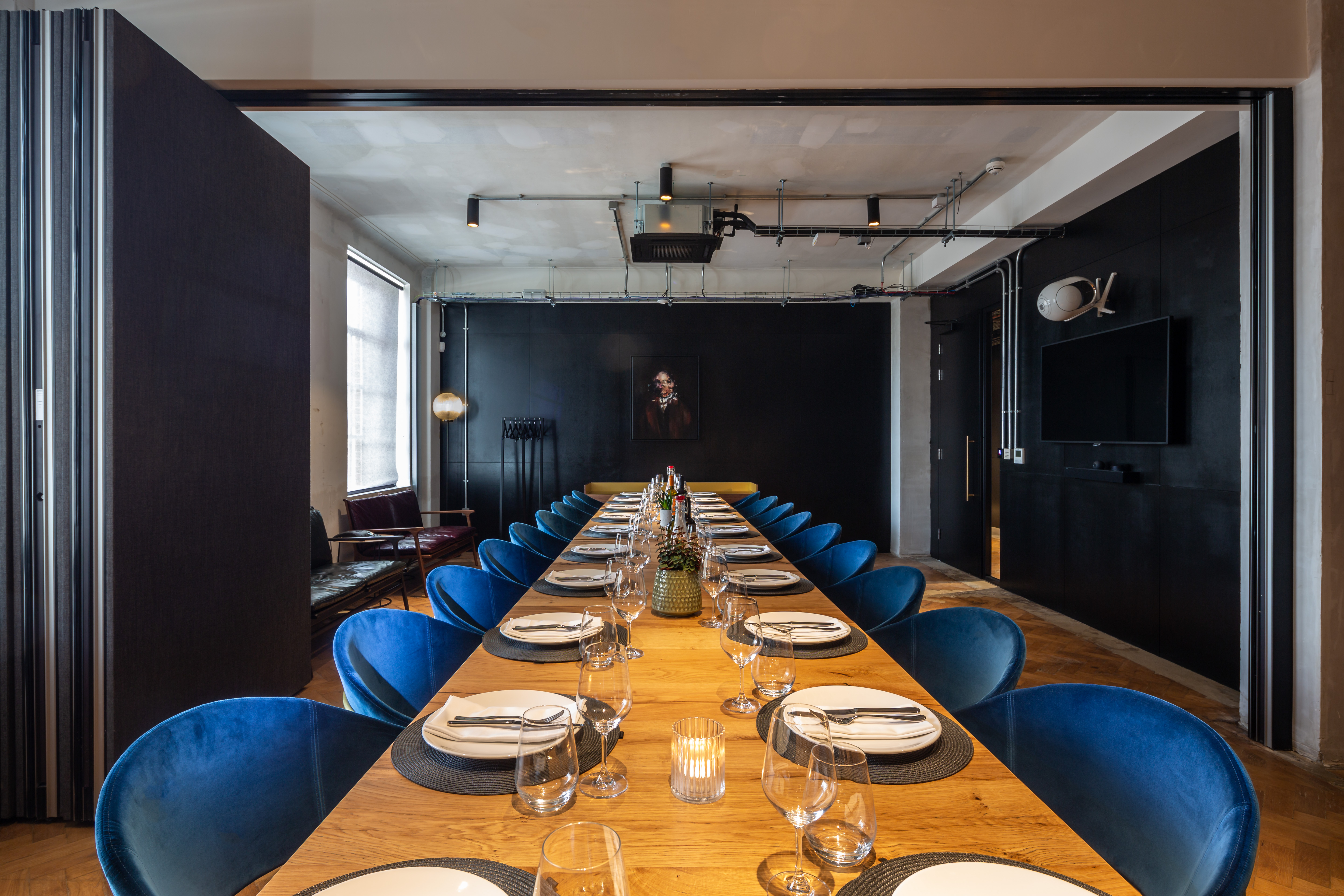 Boardroom at The Ministry featuring plush blue seating for executive strategy sessions.