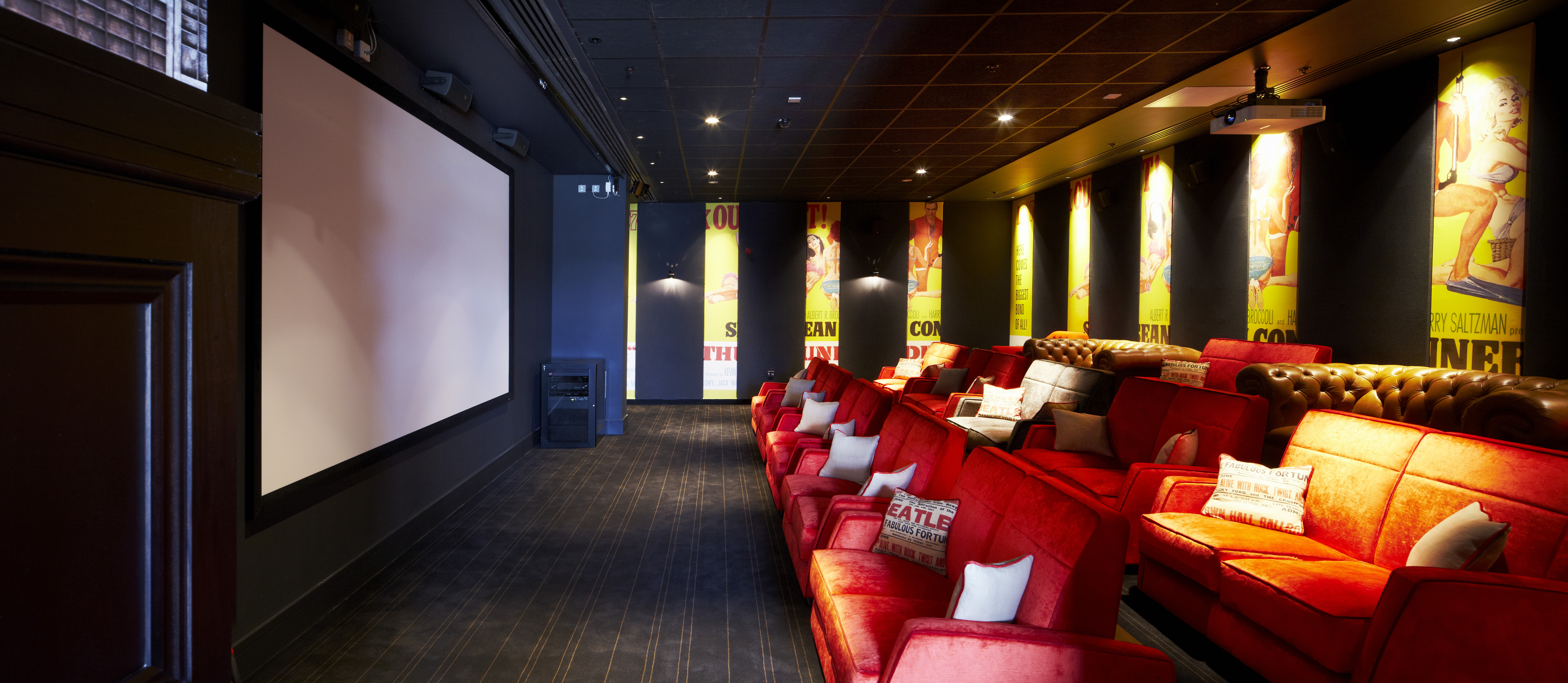 Cozy screening room in Everyman Leeds with plush red seating for private events.