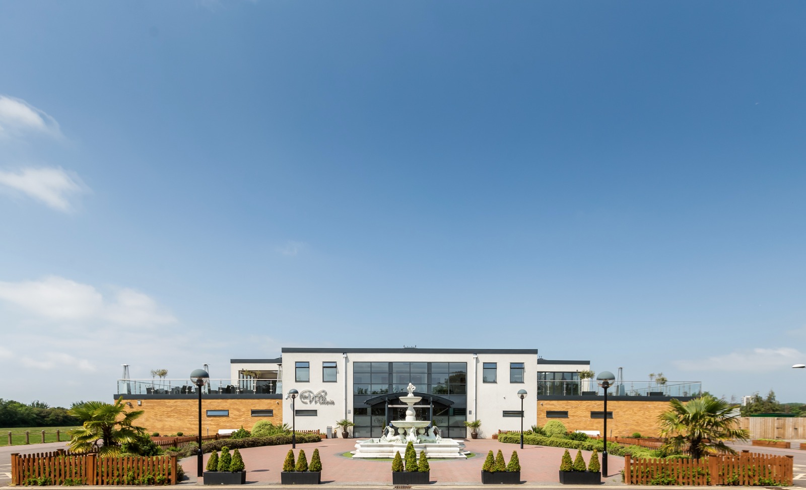 Modern event venue Premier Suite at The Willow's with large glass windows and outdoor space. - Banner