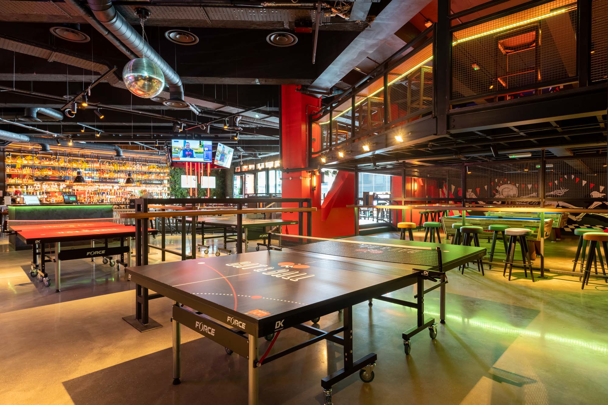 Vibrant event space with ping pong tables for corporate parties and social mixers.