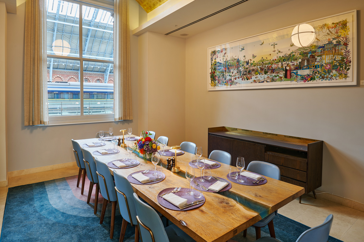 Elegant meeting space with wooden table, ideal for gatherings and events in St Pancras.