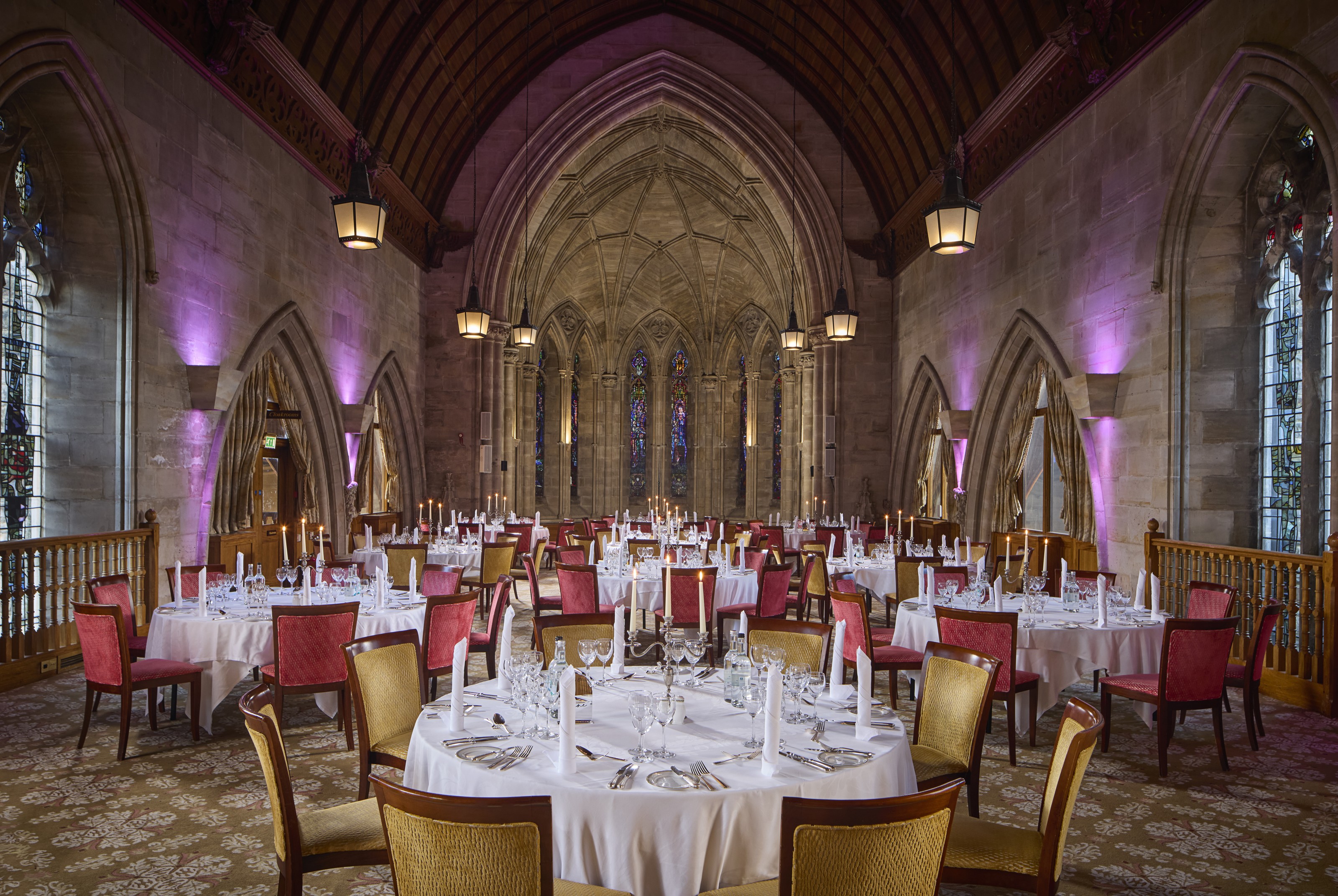 Harry Clarke gala dinner at Ashdown Park Hotel featuring dramatic architectural uplighting.