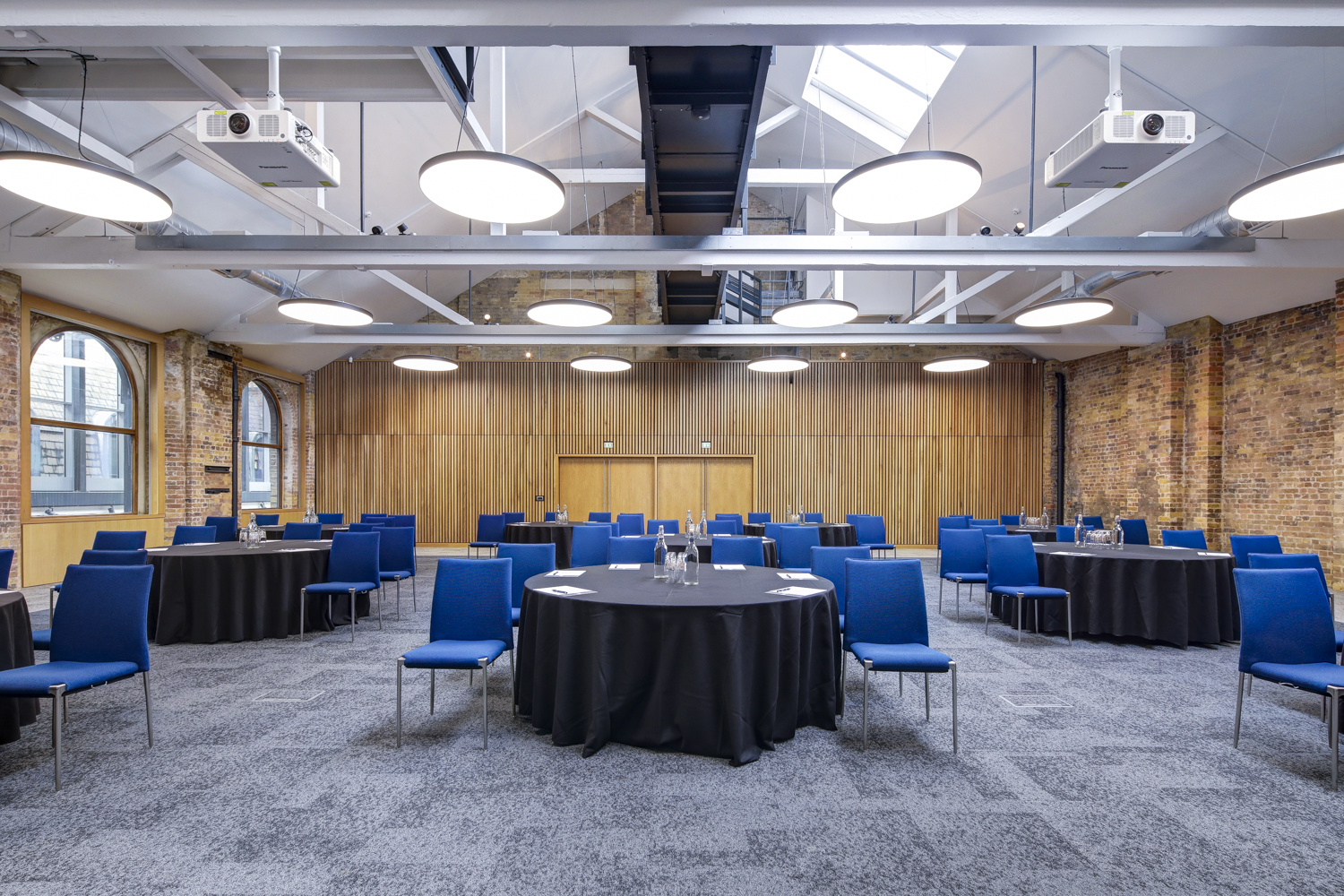 Main Hall event space, industrial modern, conference banquet.
