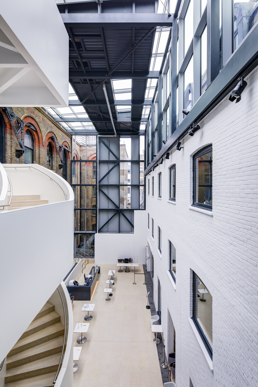 Modern event space with large windows, ideal for networking and workshops. - Banner