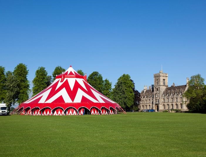 Vibrant red and white striped tent at Royal Agricultural University for outdoor events. - Banner