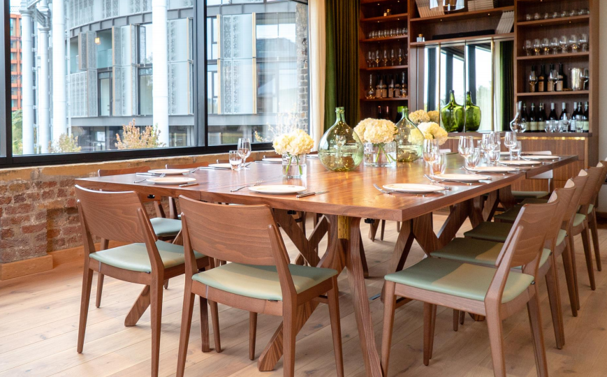 Private dining room with large wooden table, ideal for corporate meetings and events. - Banner