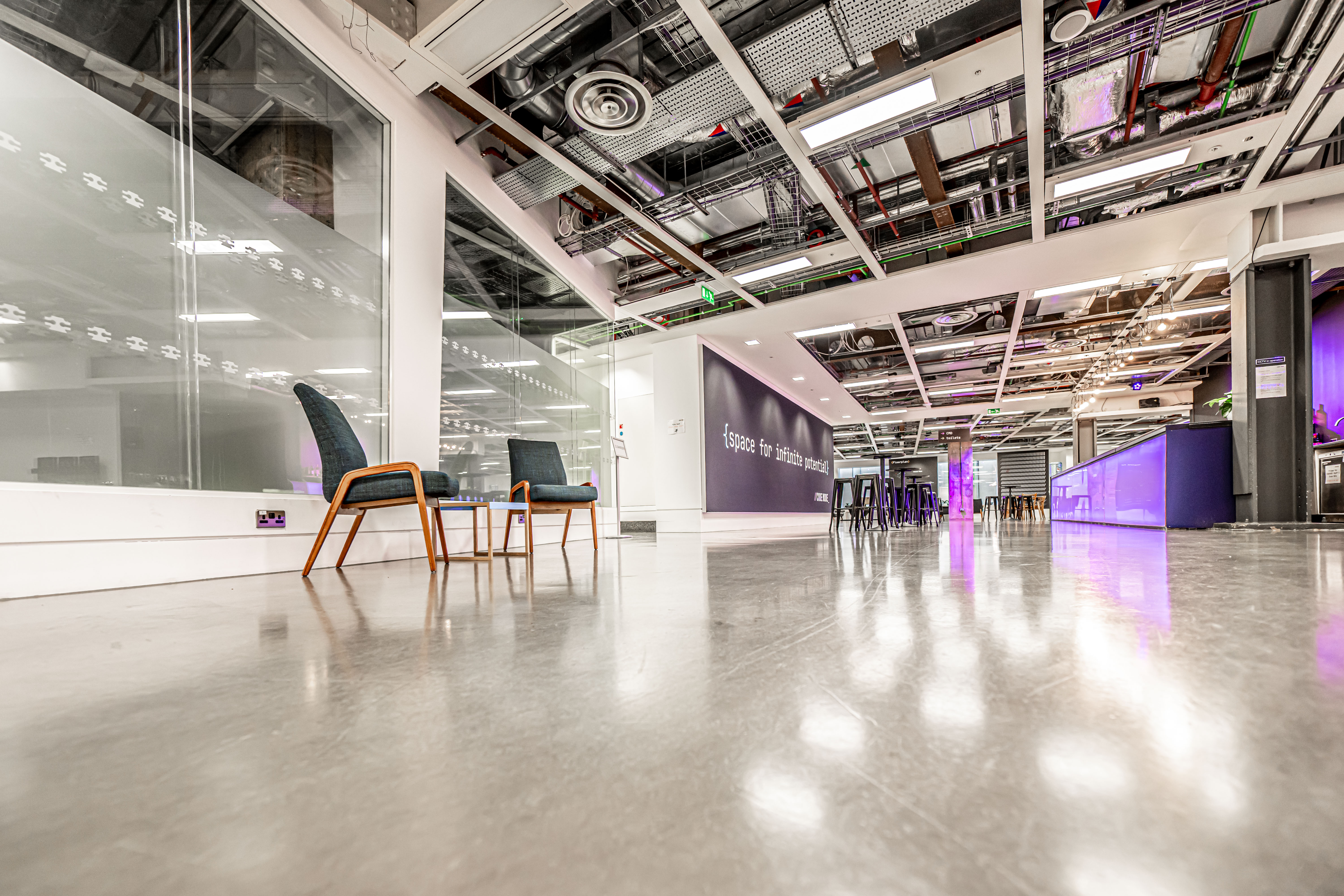 Modern breakout room: industrial chic, purple lighting, event space