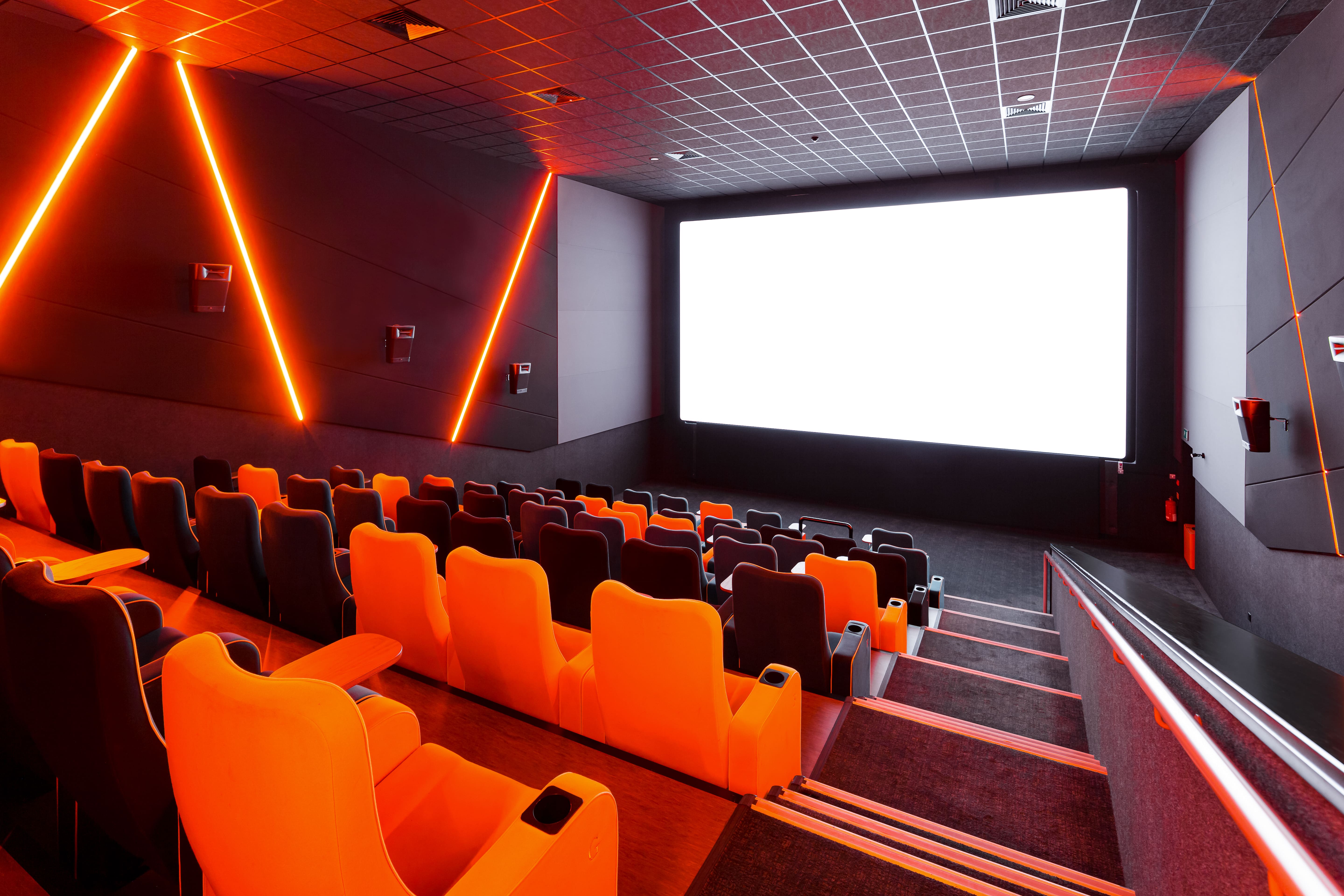Modern cinema Screen 5 at The Light Cinema Stockport with vibrant orange seating.