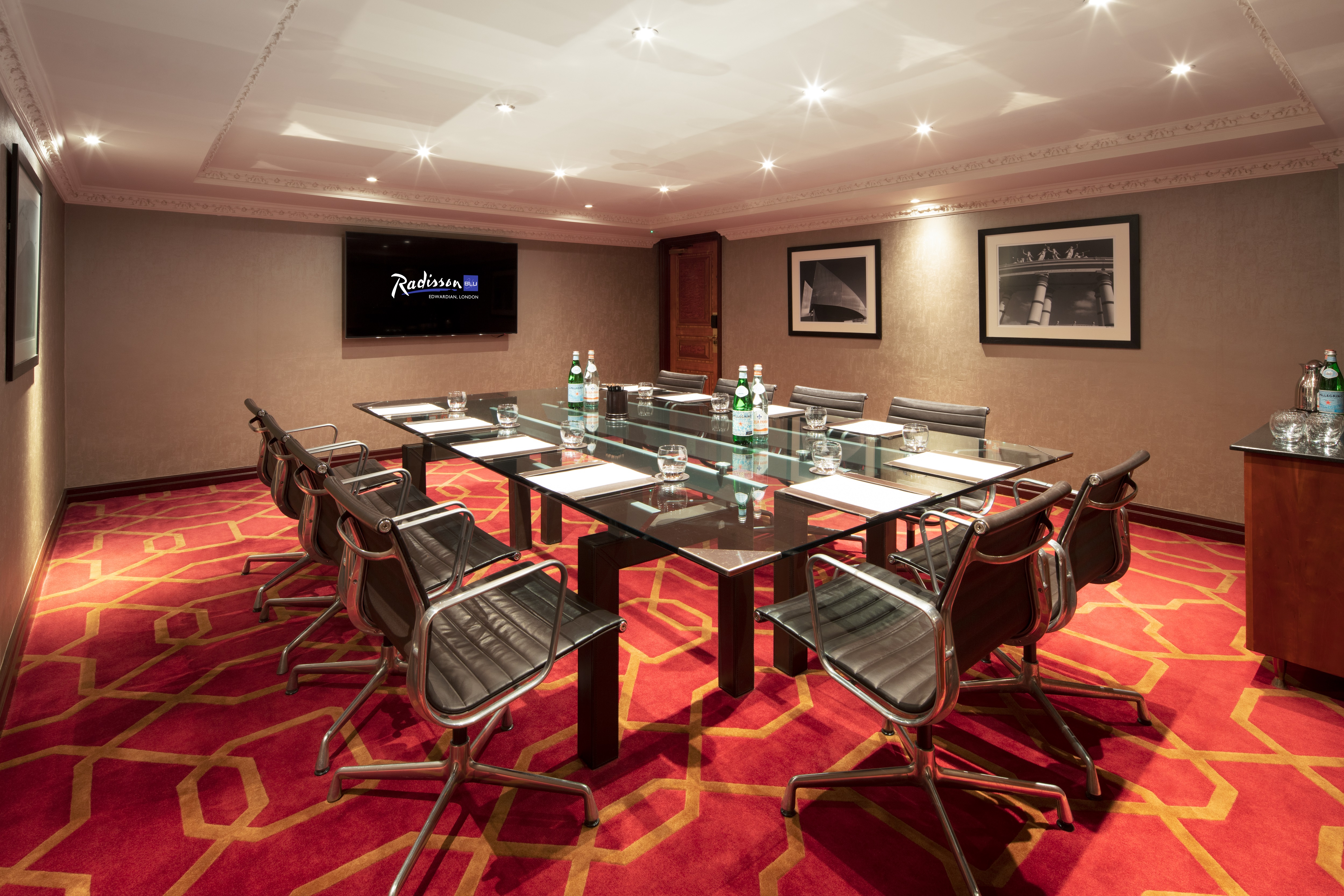 Private Room 19 at Radisson Blu Heathrow, sleek glass table, ideal for corporate meetings.