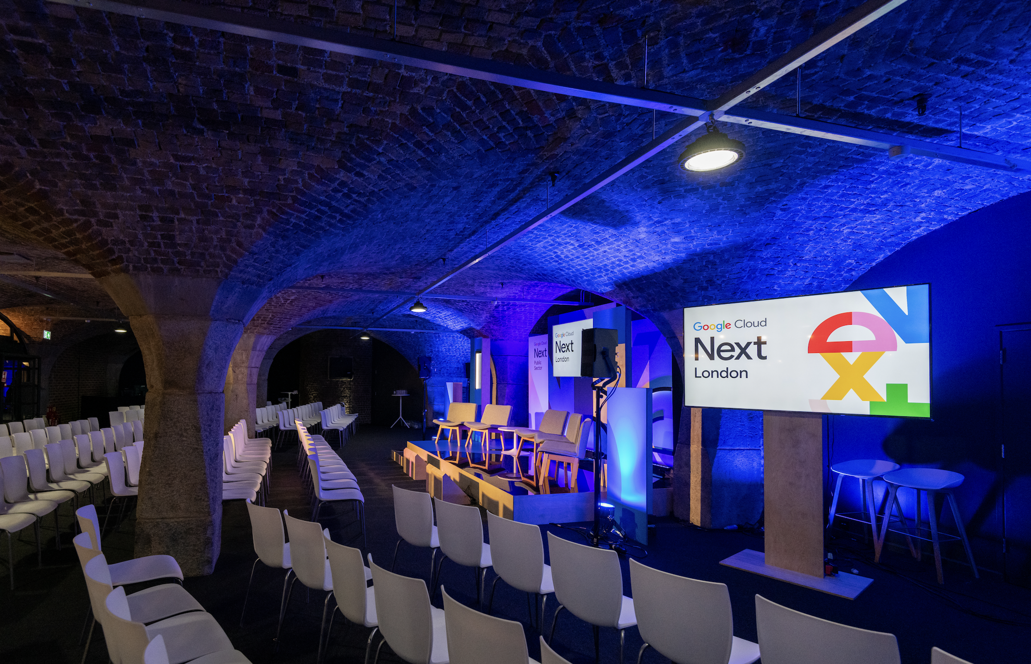 Corporate event at Tobacco Dock with LED lighting and minimalist stage for conferences or galas.