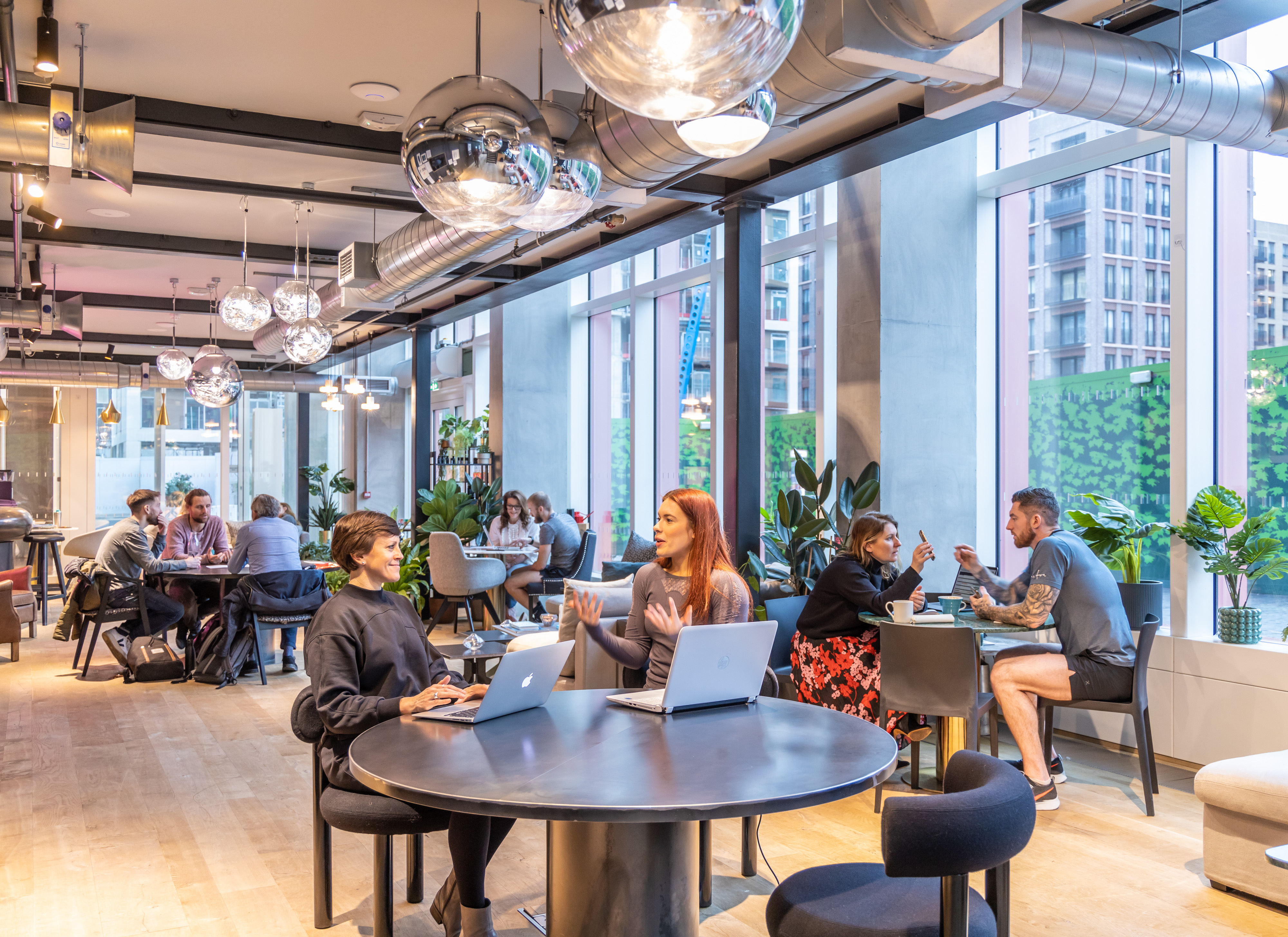 Vibrant co-working lounge with modern furnishings for meetings and events. - Banner