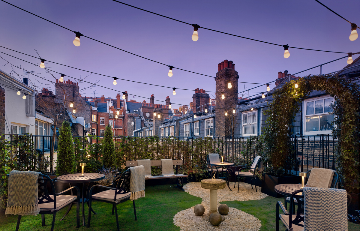 Holmes Hotel London rooftop terrace with string lights for cocktail receptions and networking events.