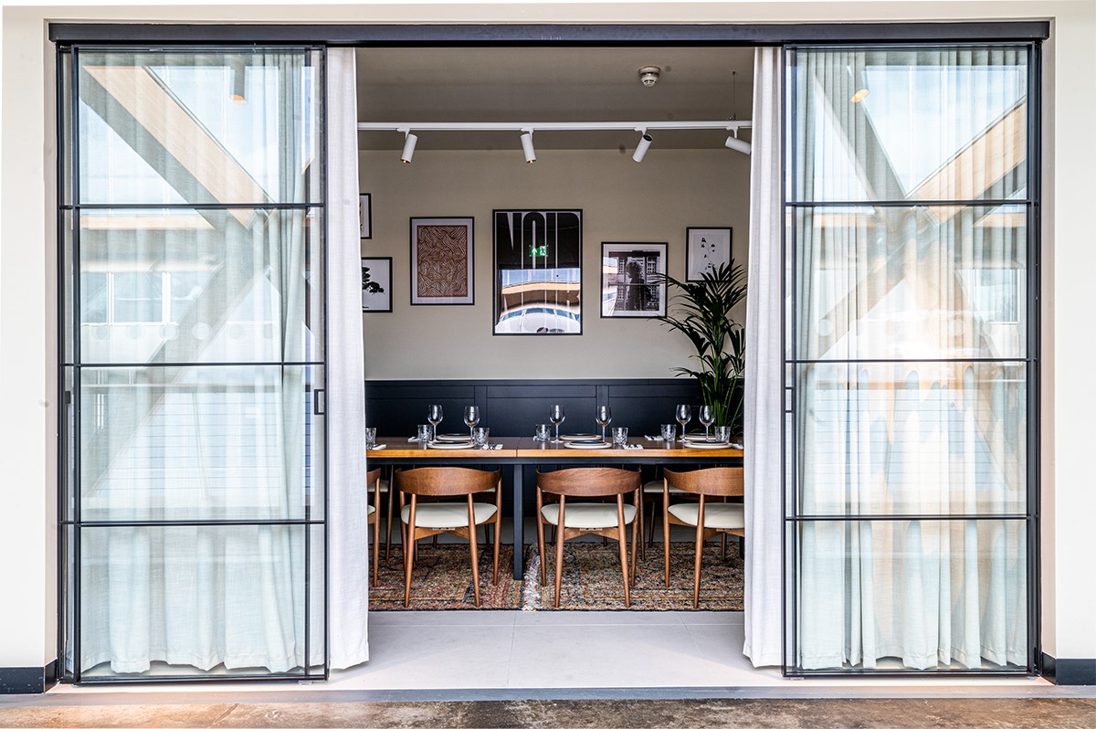 Private dining room with long table, ideal for corporate meetings and small events.