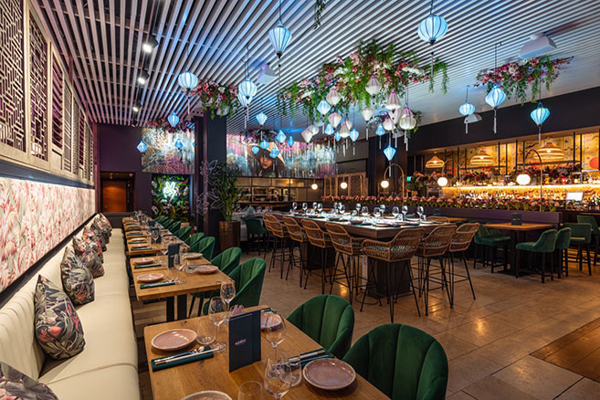 Full restaurant with vibrant decor, ideal for events and gatherings at Namii Kitchen & Cocktails. - Banner