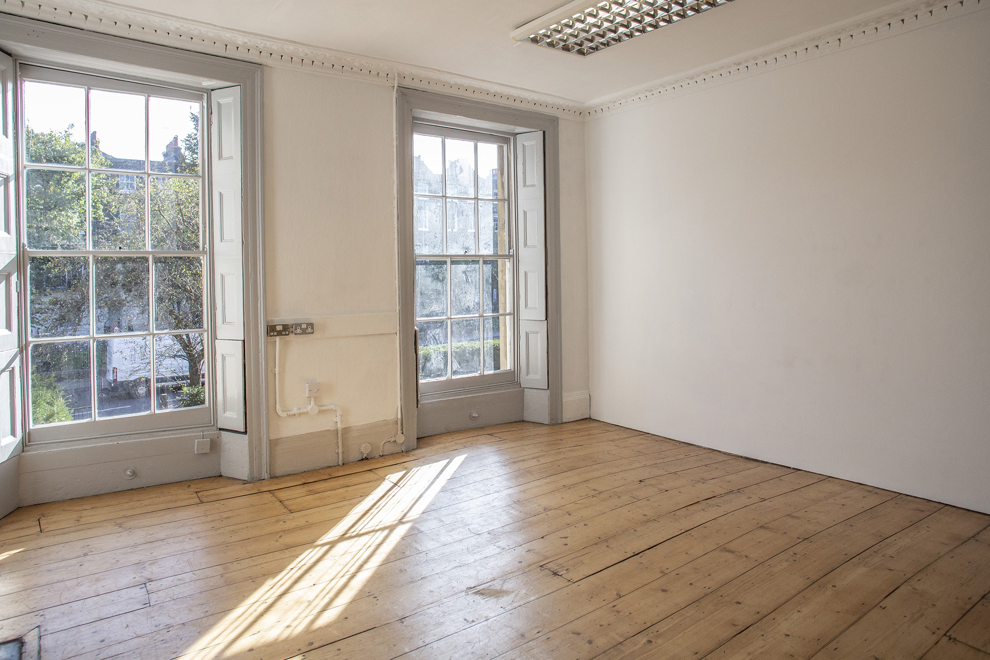 Bright meeting space with large windows, perfect for gatherings and brainstorming sessions.