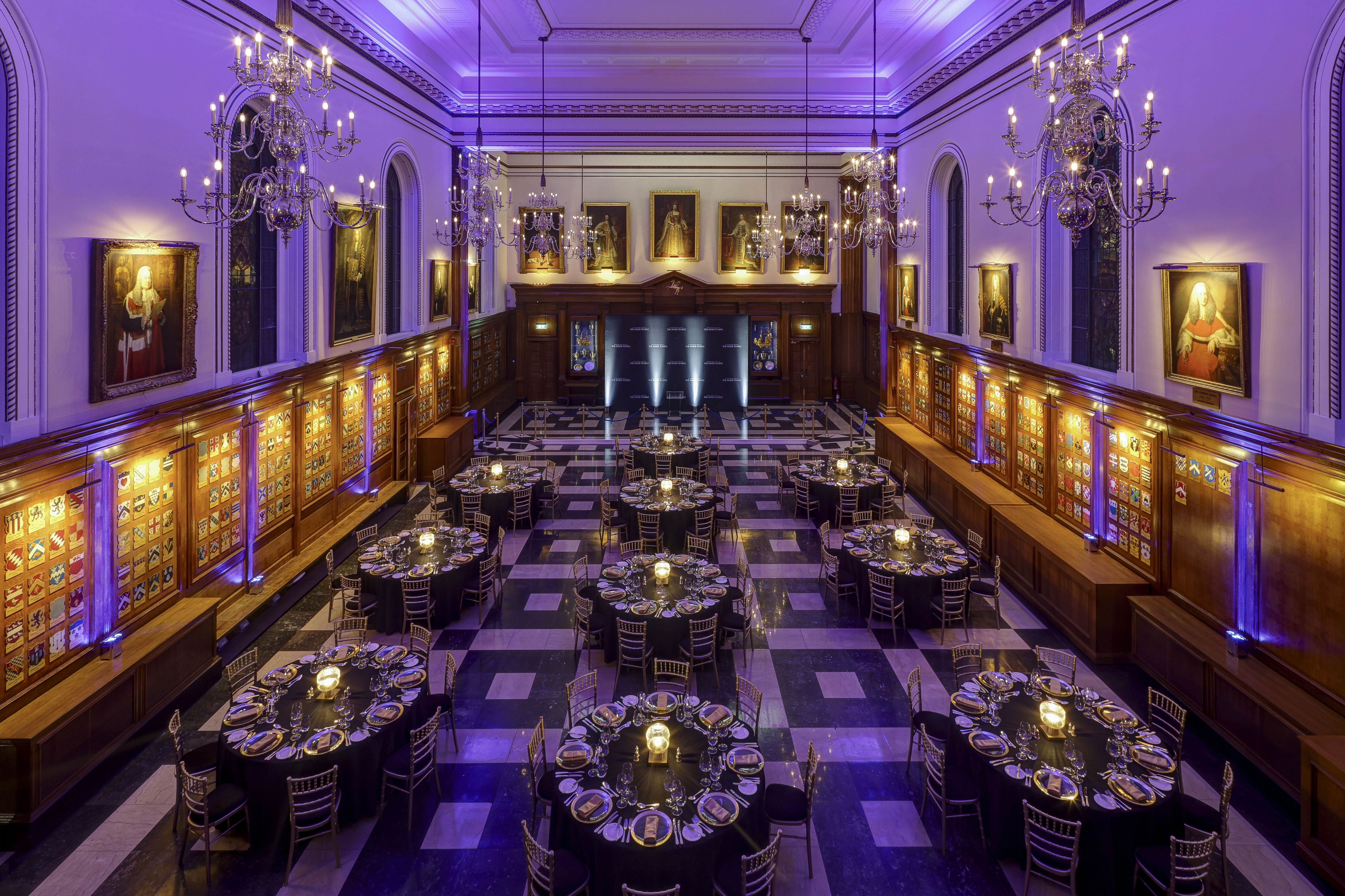 Inner Temple Hall gala with purple uplighting and formal table arrangements for historic venue events.