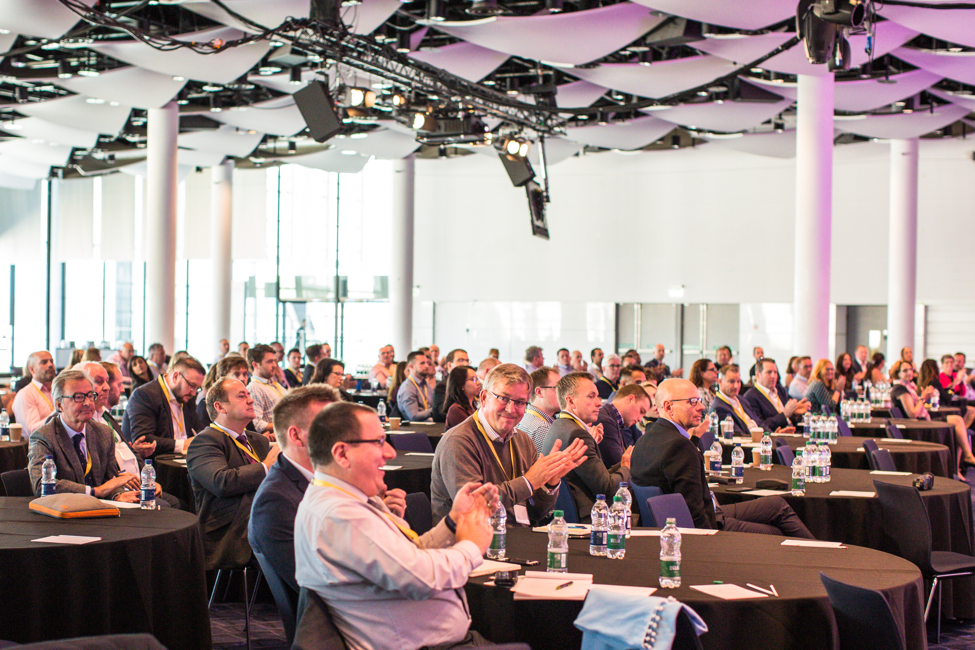 Wembley Stadium Great Hall conference with round tables for business seminars and networking events.