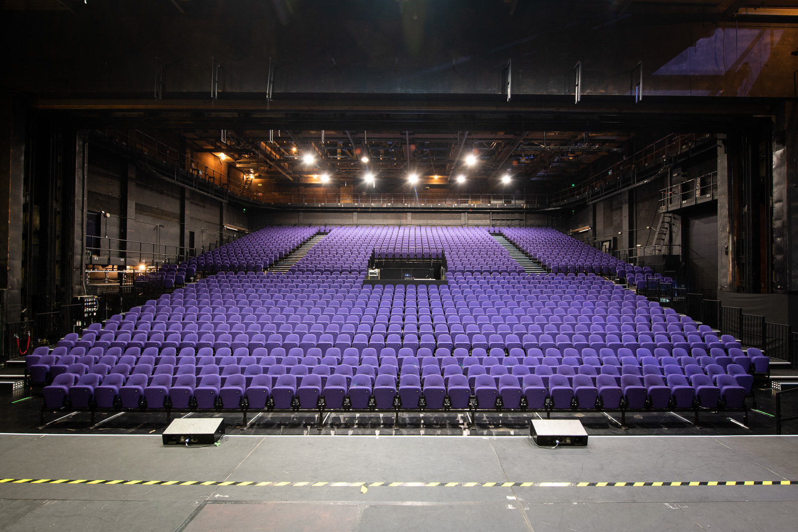 Empty auditorium with purple seats at Troubadour Wembley Park Theatre for events. - Banner