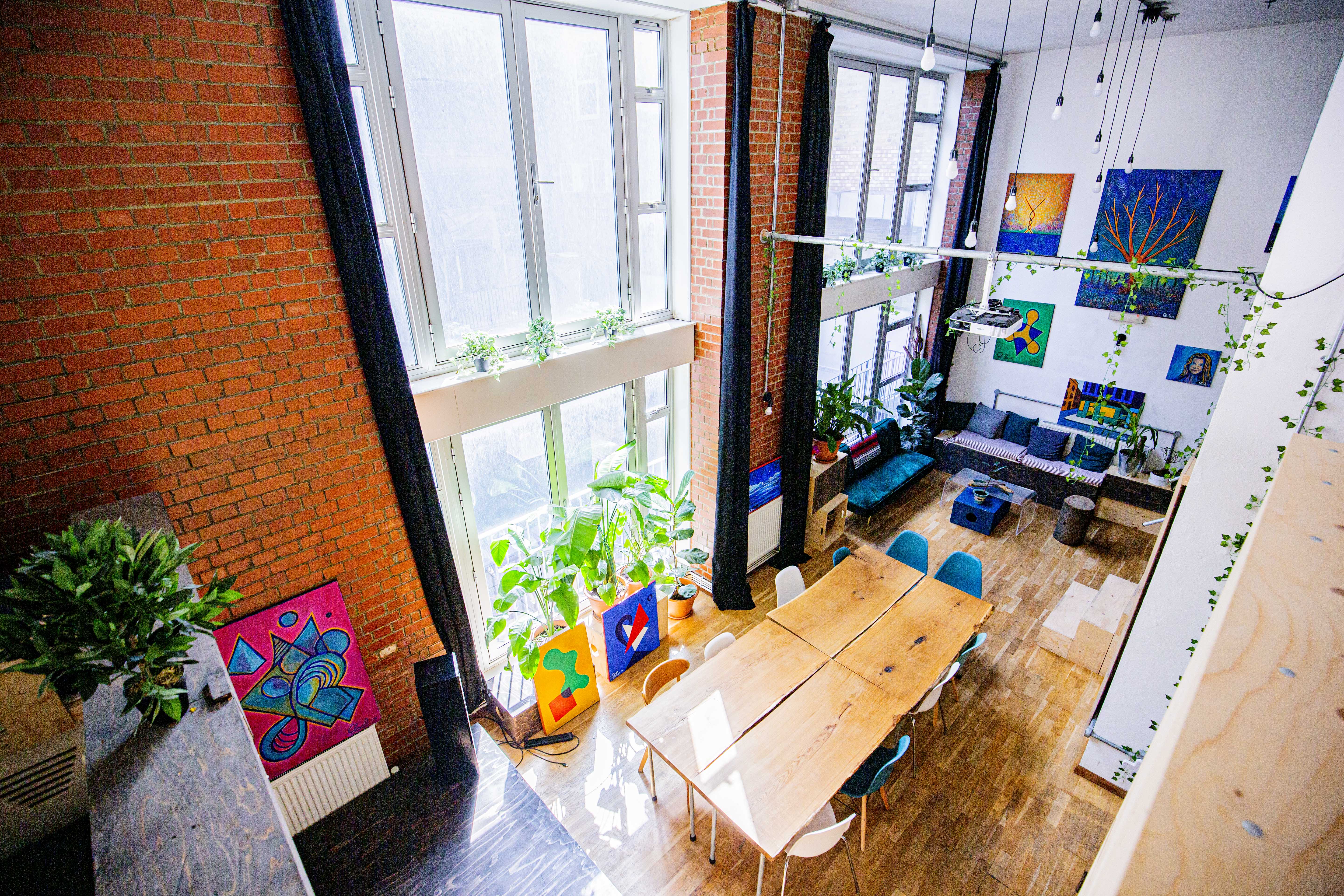 Bright modern meeting space with high ceilings at House of Transformation venue for events. - Banner