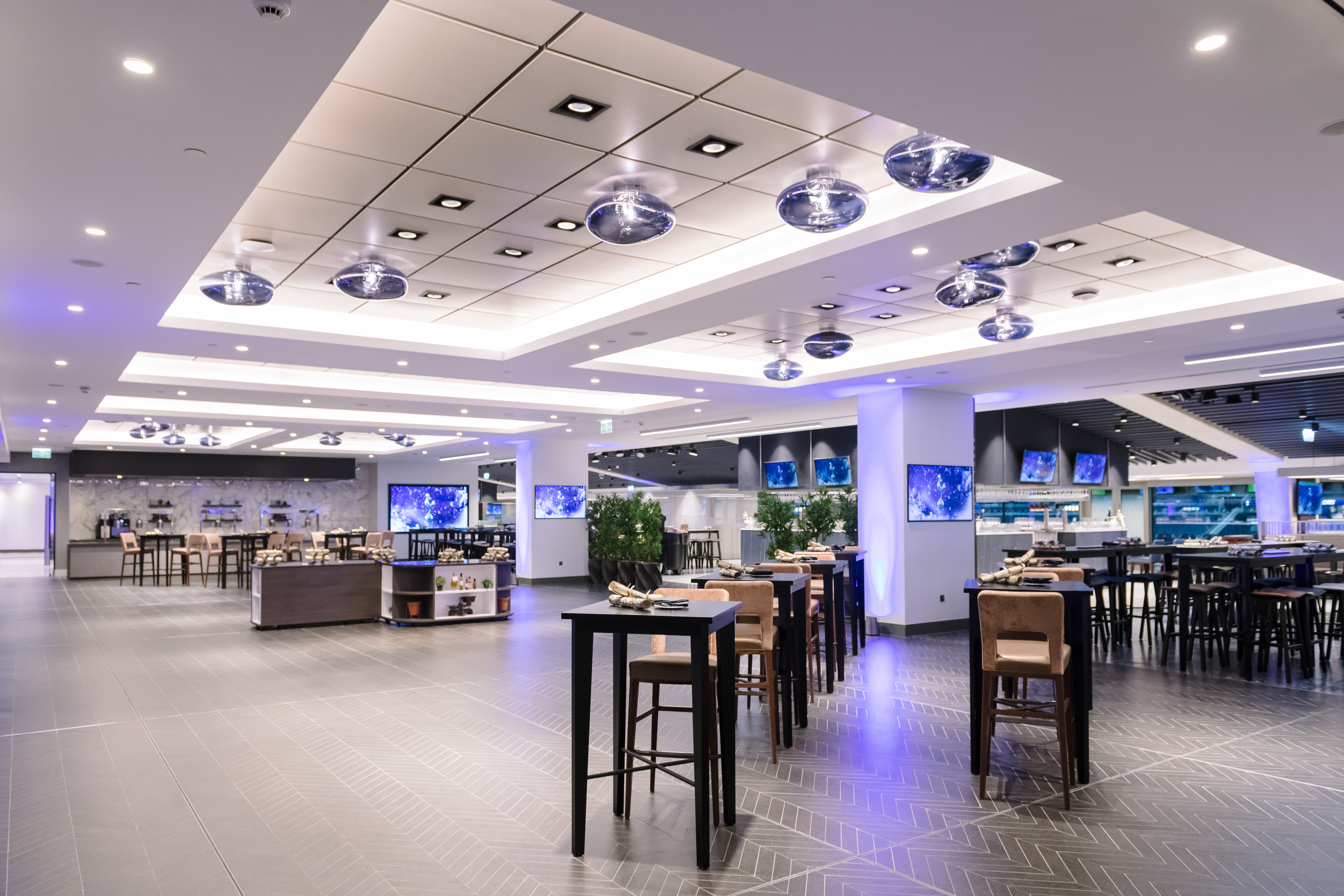 Modern event space at Tottenham Hotspur Stadium with ambient lighting, perfect for gatherings.