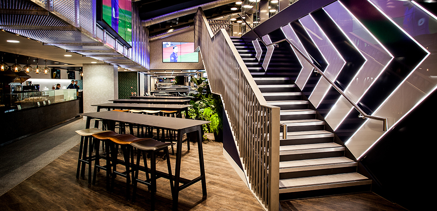 Modern event space at Tottenham Hotspur Stadium with staircase for networking and conferences.