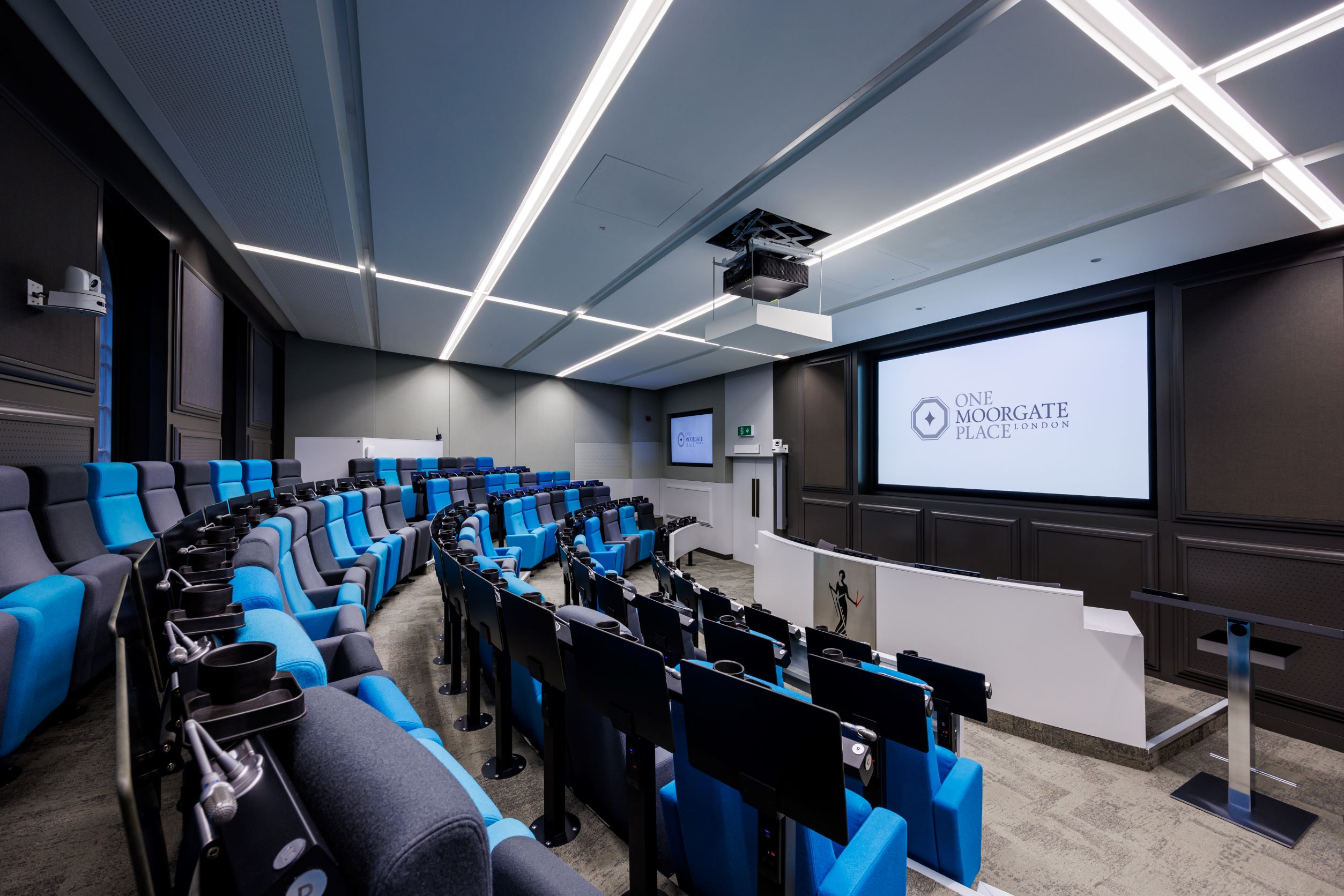 Modern auditorium, tiered seating, corporate event, product launch