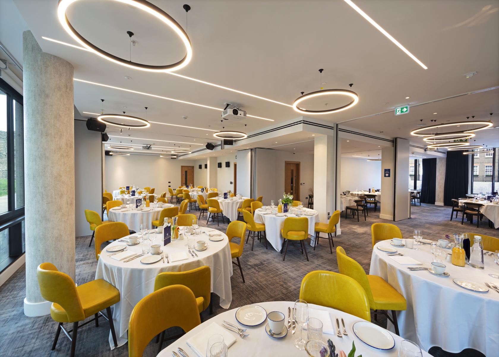 Royal Suite banquet setup with white linens and yellow chairs, perfect for events. - Banner