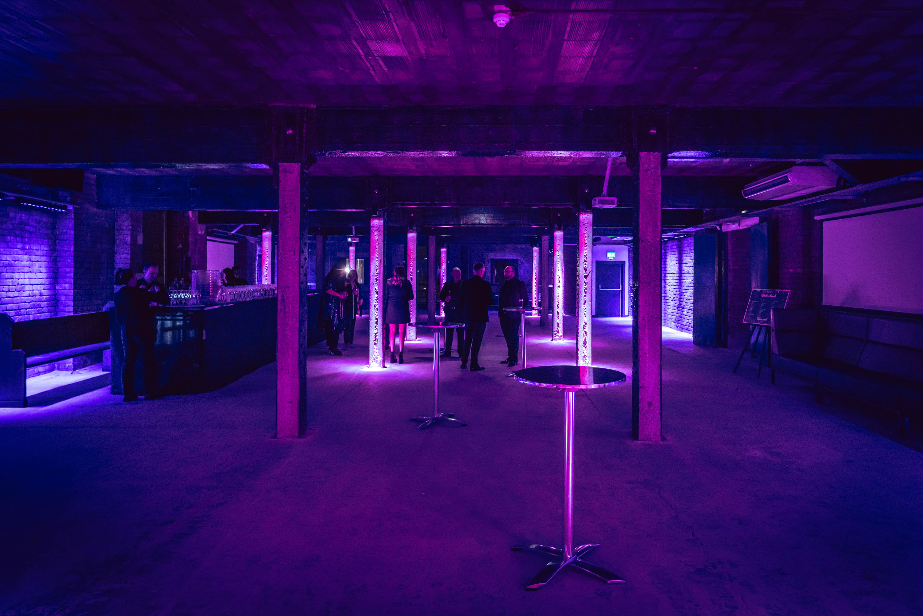 Tobacco Stores event space with purple lighting, ideal for networking and cocktail receptions.