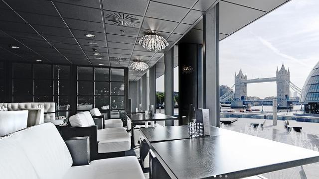 Sleek event space with large windows at Tower Bridge, perfect for corporate meetings. - Banner