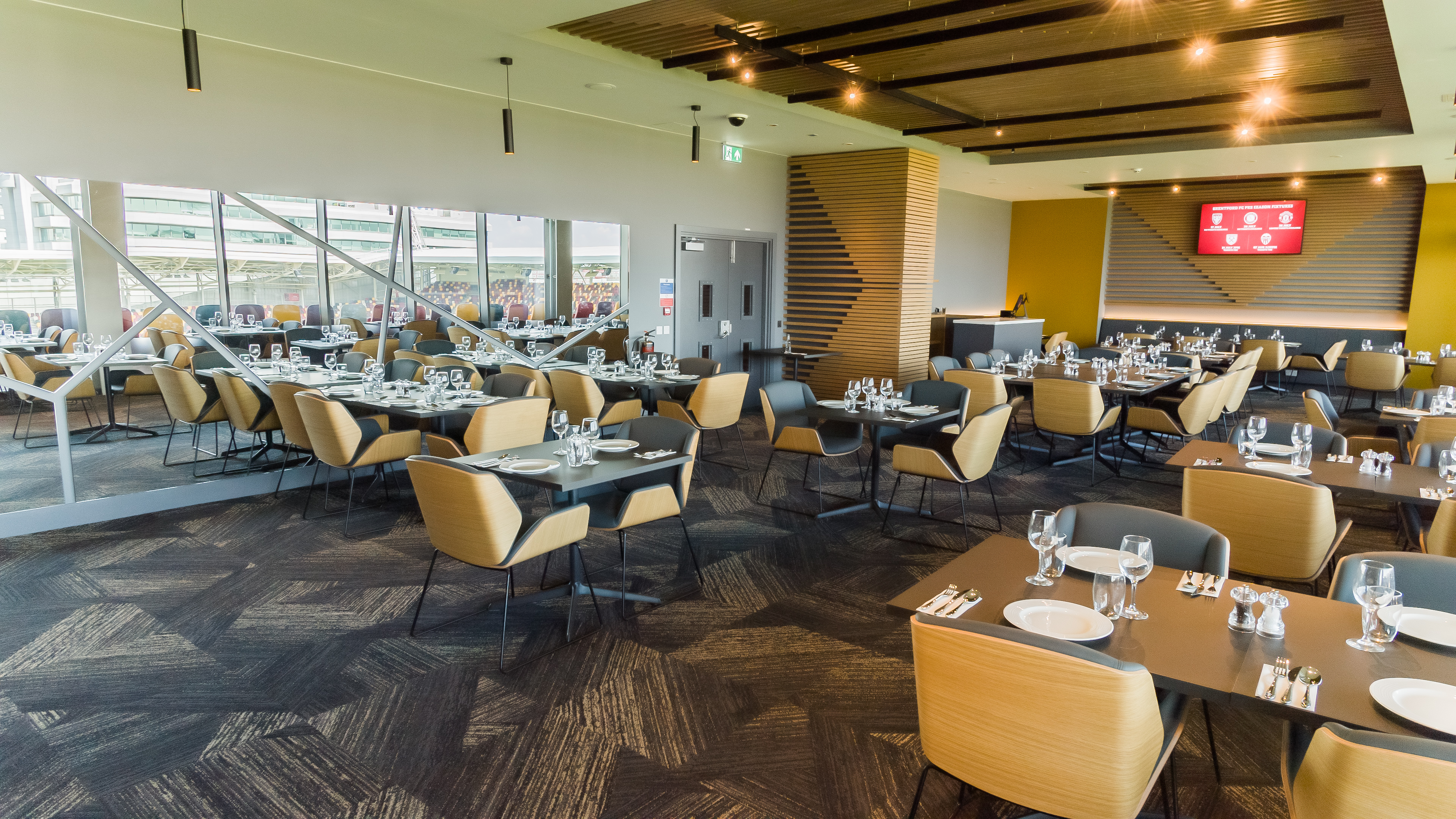 Modern dining space at Brentford FC for corporate events and meetings. - Banner