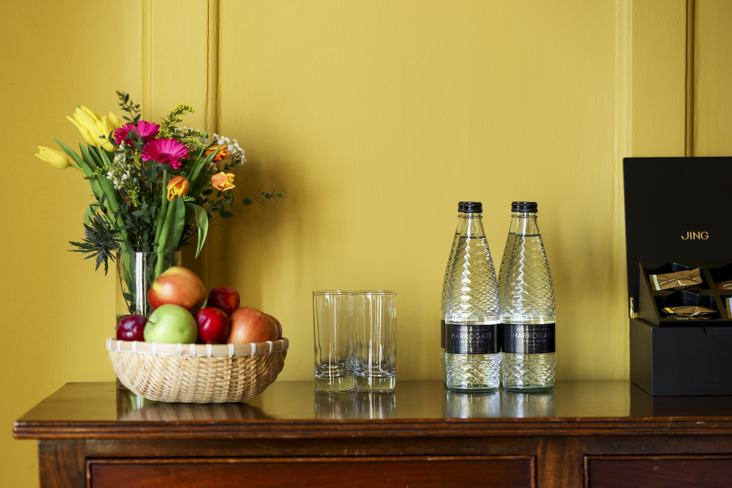 Elegant refreshment station in Queen's Room for meetings and events with flowers and glassware.